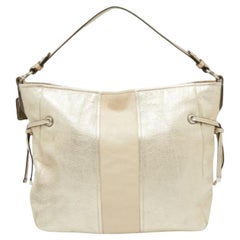 Bolso bandolera Coach de cuero dorado claro con cordón lateral