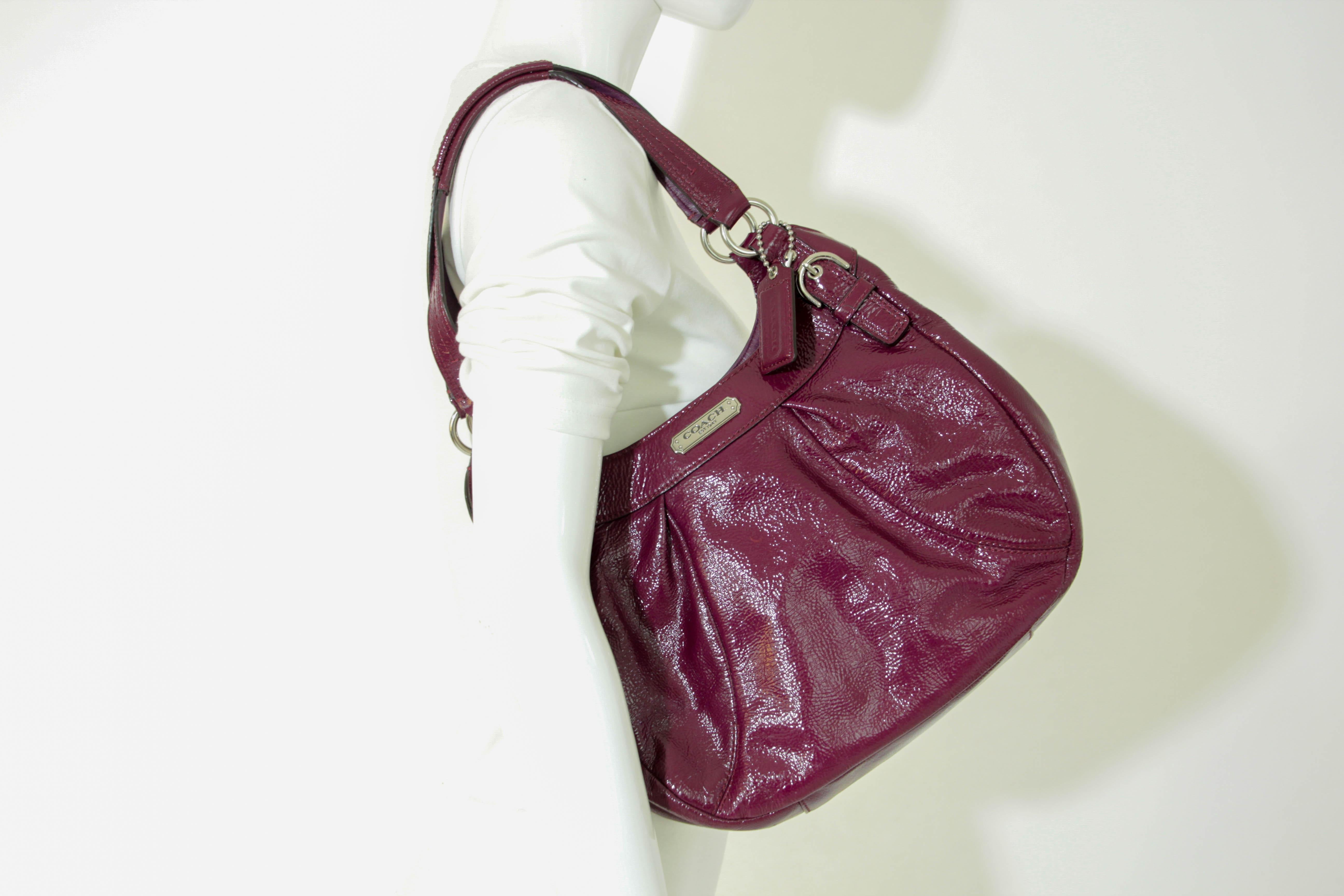 Coach Purple Patent Leather Hobo Satchel Shoulder Bag Purse is rich raspberry, plum purple patent leather with silver tone hardware. 
Coach Patent Leather Large Hobo Shoulder Bag.
3 interior sections, 1 zippered and 2 magnetic snap closure