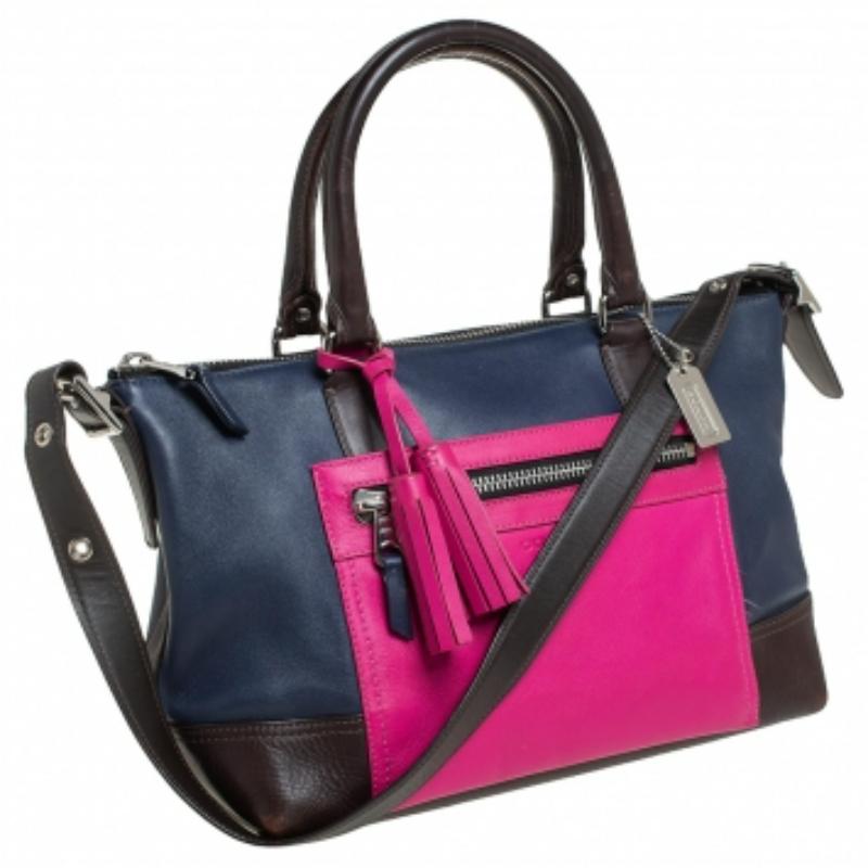This gorgeous tote is from Coach. It carries a multicolored exterior made of quality leather and it has been equipped with a zip pocket on the front, two top handles, a shoulder strap, and a spacious fabric interior. The tote is ideal for everyday