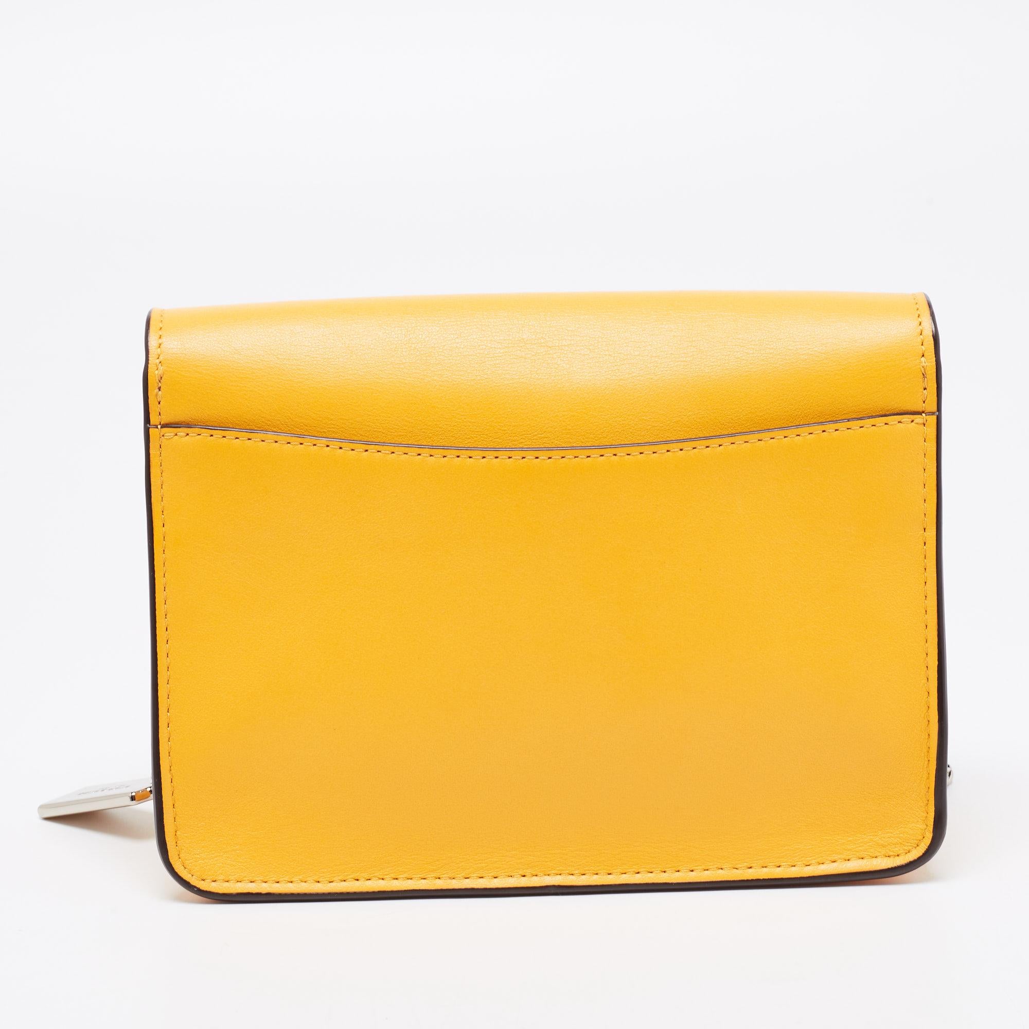 Elegance meets luxury in this Bowery shoulder bag from the House of Coach. It is created using mustard leather, with a lock closure perched on the front. It features an Alcantara-lined interior, silver-tone hardware, and a sturdy chain strap. This