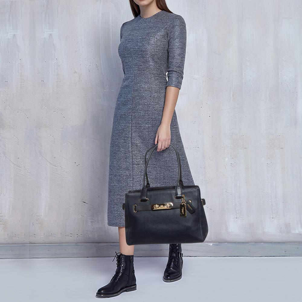 This firm tote bag by Coach is easy to carry and is a fusion of trend and functionality. A splendid complement to your outfit will be this popular bag in blue hues. Showcasing a timeless leather bag that is a perfect blend of style and utility. It
