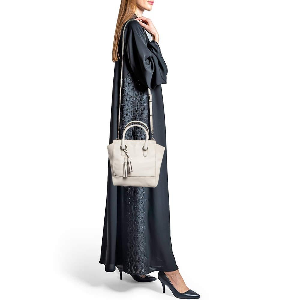 The simple silhouette and the use of durable materials for the exterior bring out the appeal of this Coach bag for women. It features comfortable handles and a well-lined interior.