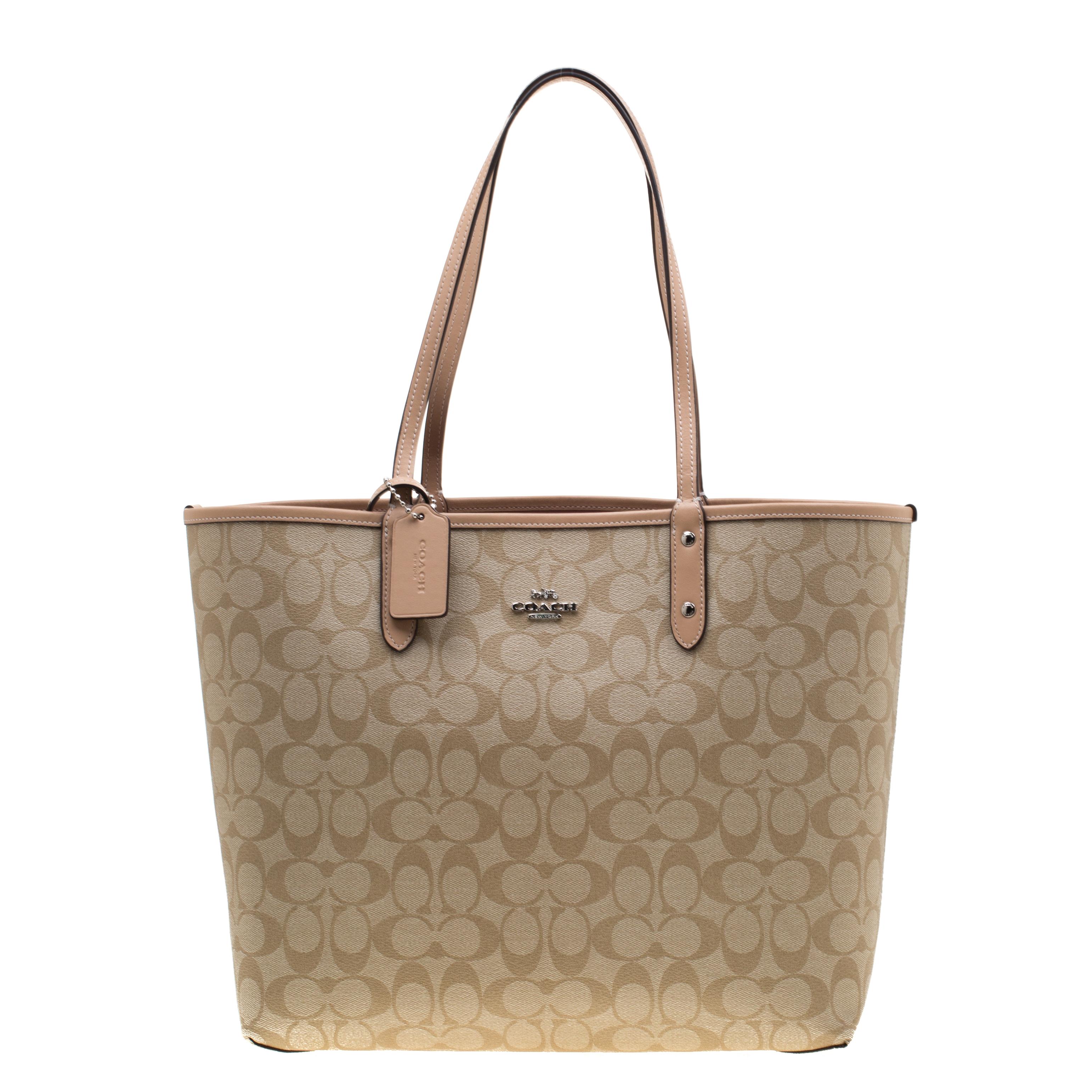 This Reversible City tote by Coach has a structure that simply spells sophistication. The bag has a signature canvas side and a floral printed one and it is elegantly held by two top handles. The tote is sized to store your necessities well, and the