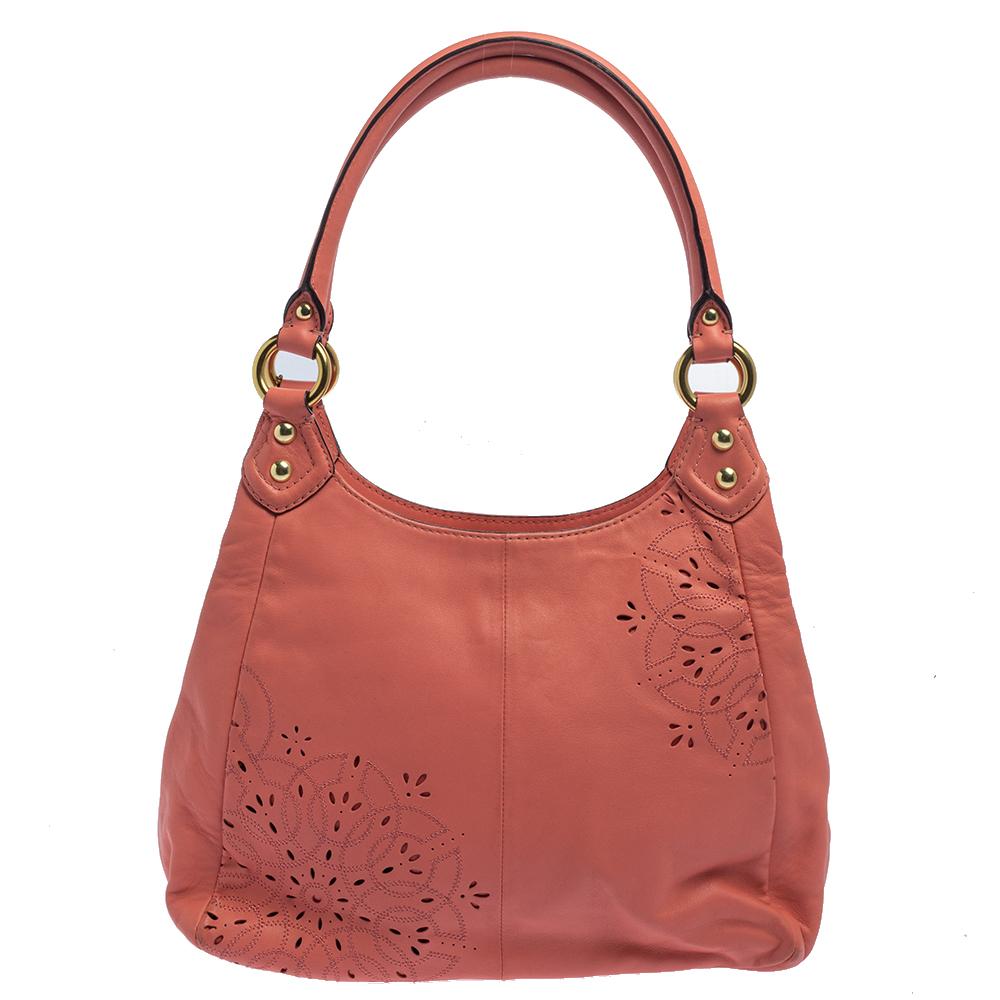 Step out in style with this hobo from Coach. It is crafted from pink leather and styled with floral cutouts on the exterior. The bag, equipped with two top handles and satin-lined compartments, is perfect to flaunt on your shopping trips and casual