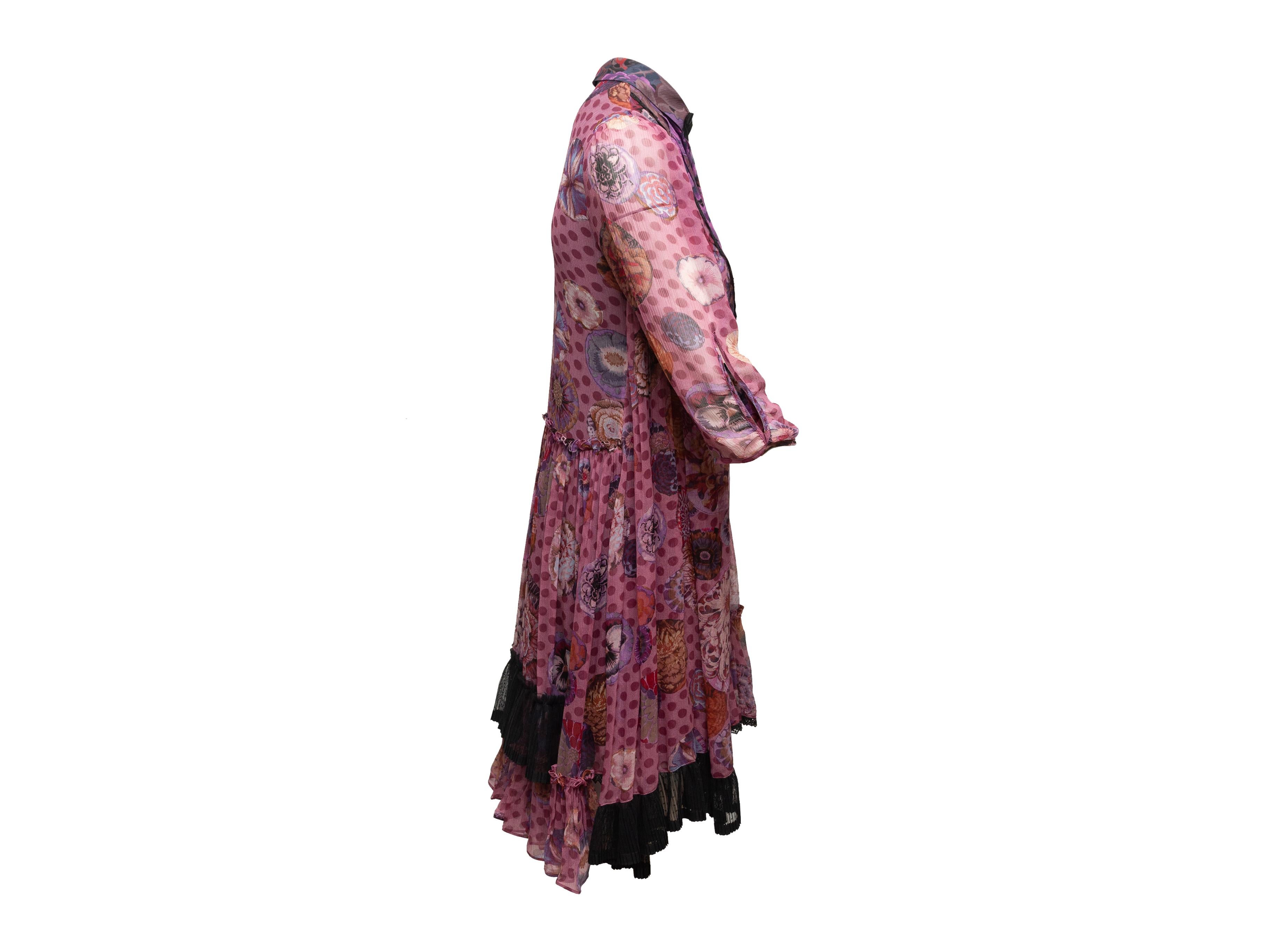 Product details: Purple and multicolor silk long sleeve dress by Coach. Floral polka dot print throughout. Tie accent at neck. Pleating at bust and skirt. Asymmetrical hem. Button closures at front. 32