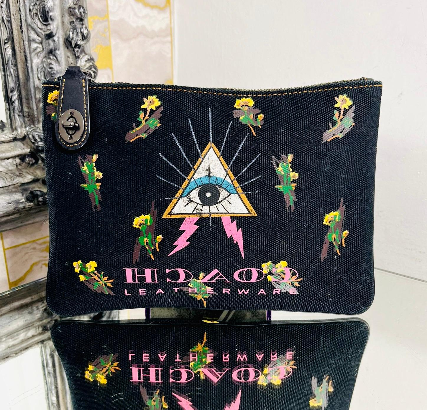 Coach Pyramid Eye Canvas Pouch

Black pouch designed with a mixed print of florals and the Pyramid Eye symbol.

Detailed with pink, reversed lettering form the Coach logo at the front.

Featuring leather pull tab with turn-lock closure.

Size –