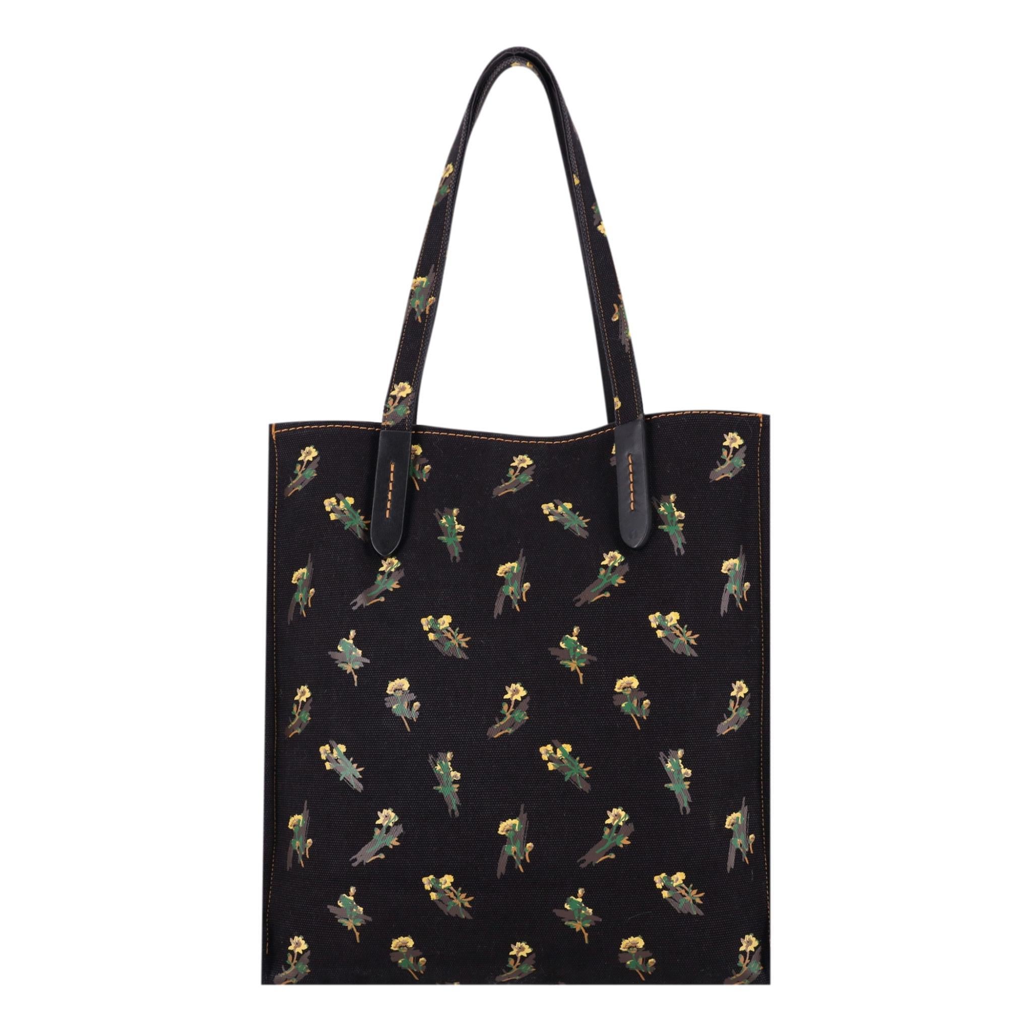 Coach Pyramid Eye Canvas Tote Bag

Black bag designed with a mixed print of florals and the Pyramid Eye symbol.

Detailed with pink, reversed lettering form the Coach logo at the front.

Featuring dual top handle and leather accents with removable