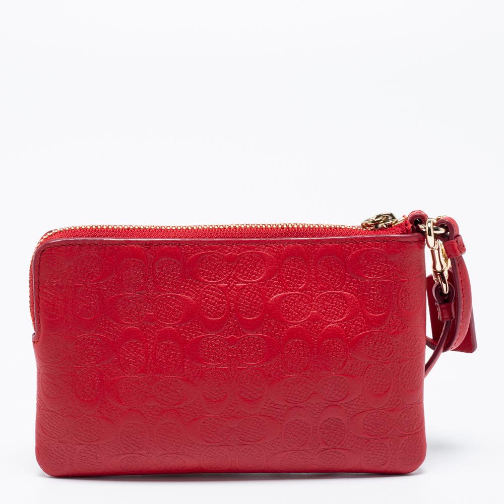 Carry this Coach wristlet for those casual outings or dinners. Crafted from a signature embossed patent leather body, this bag comes fitted with a wristlet. Keep your evening essentials like a cell phone, cards, and currency in the canvas-lined