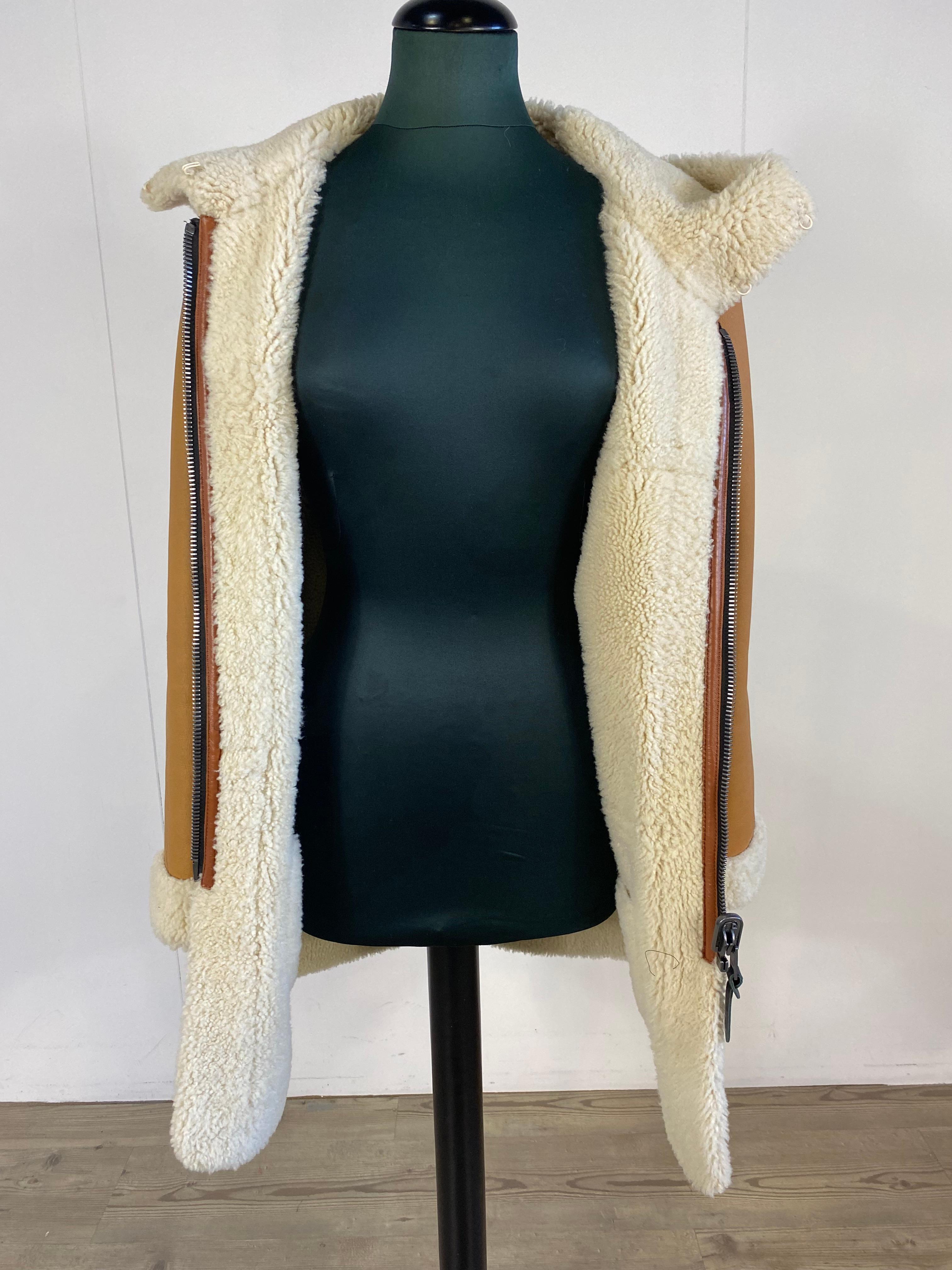 Coach sheepskin in light brown leather, with hood, there are 2 pockets on the front at leg height, new never worn.
Measurements, shoulder 43cm, chest 47cm, sleeve 64cm, length 82cm.