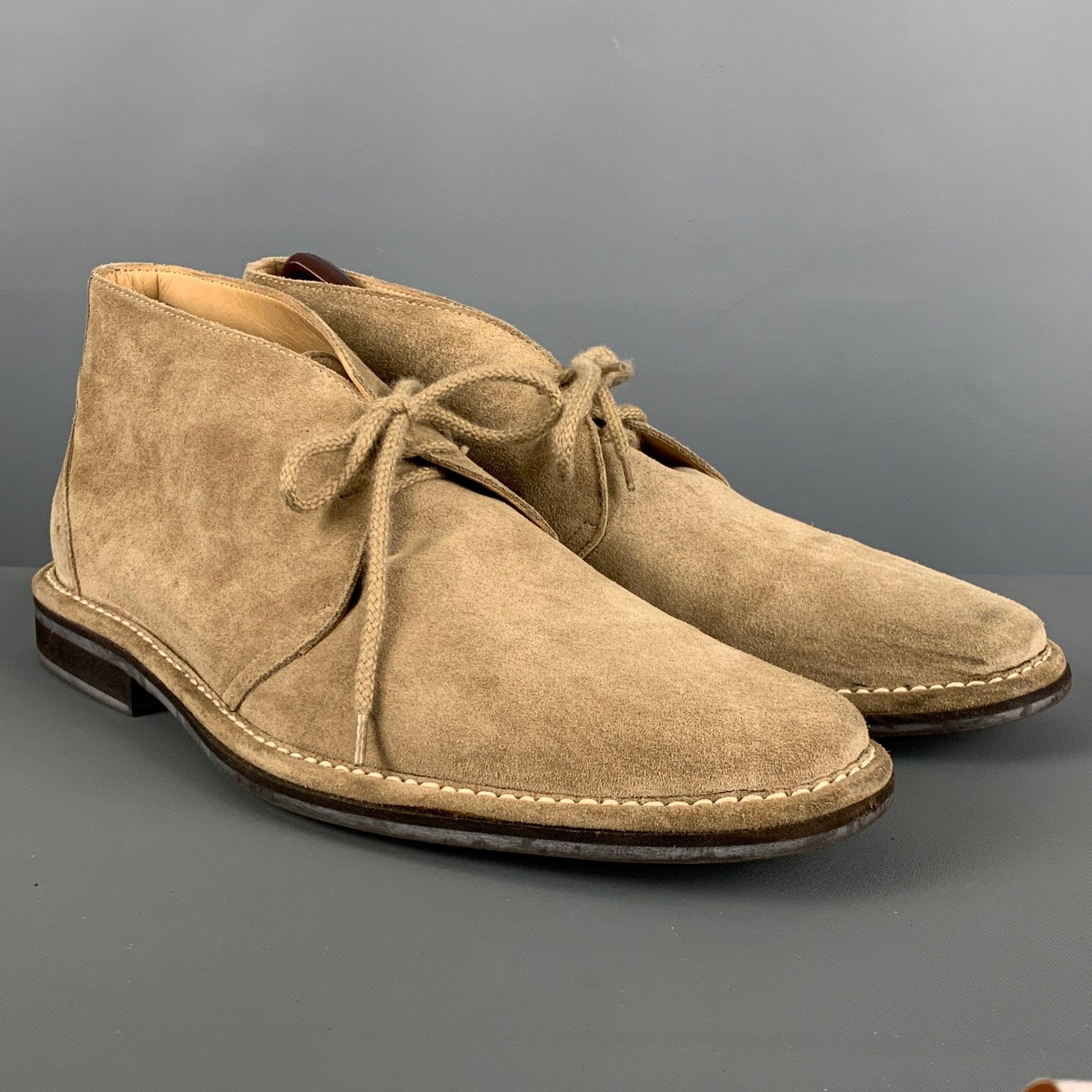 COACH boots comes in a beige suede featuring a chukka style, round toe, and a lace up closure. Comes with box. Made in Italy.Very Good Pre-Owned Condition. 

Marked:   10 1/2 DP 982G05 

Measurements: 
  Length: 13 inches Width: 4.75 inches Height: