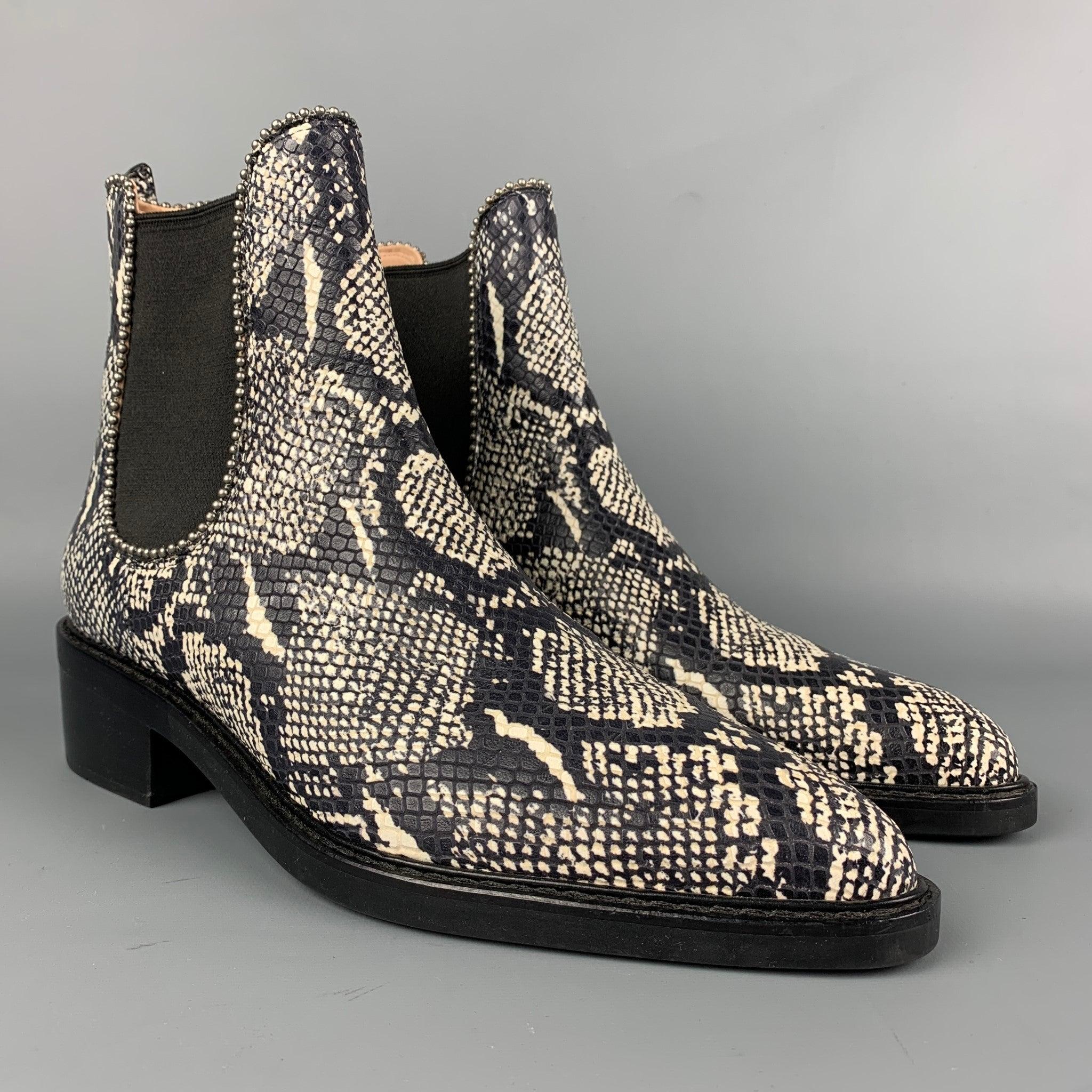 COACH ankle boots comes in a black & white textured embossed faux snake skin featuring a chelsea style, pointed toe, studded details, and a stacked heel.
Very Good
Pre-Owned Condition. 

Marked:   11 B  

Measurements: 
  Length: 11.5 inches  Width:
