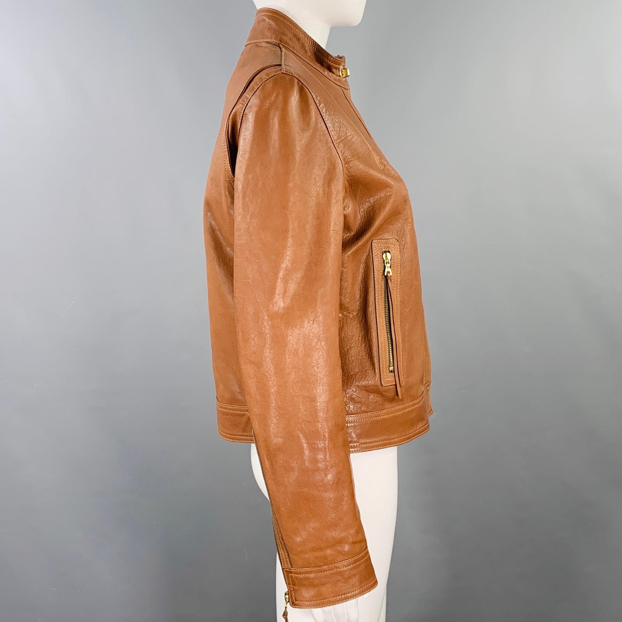 COACH jacket
in a brown leather featuring gold tone metal hardware, zip pockets, and hidden zip up closure with gold tone turn lock detail. Made in USA.Very Good Pre-Owned Condition. Minor mark. 

Marked:   8 

Measurements: 
 
Shoulder: 15.5 inches