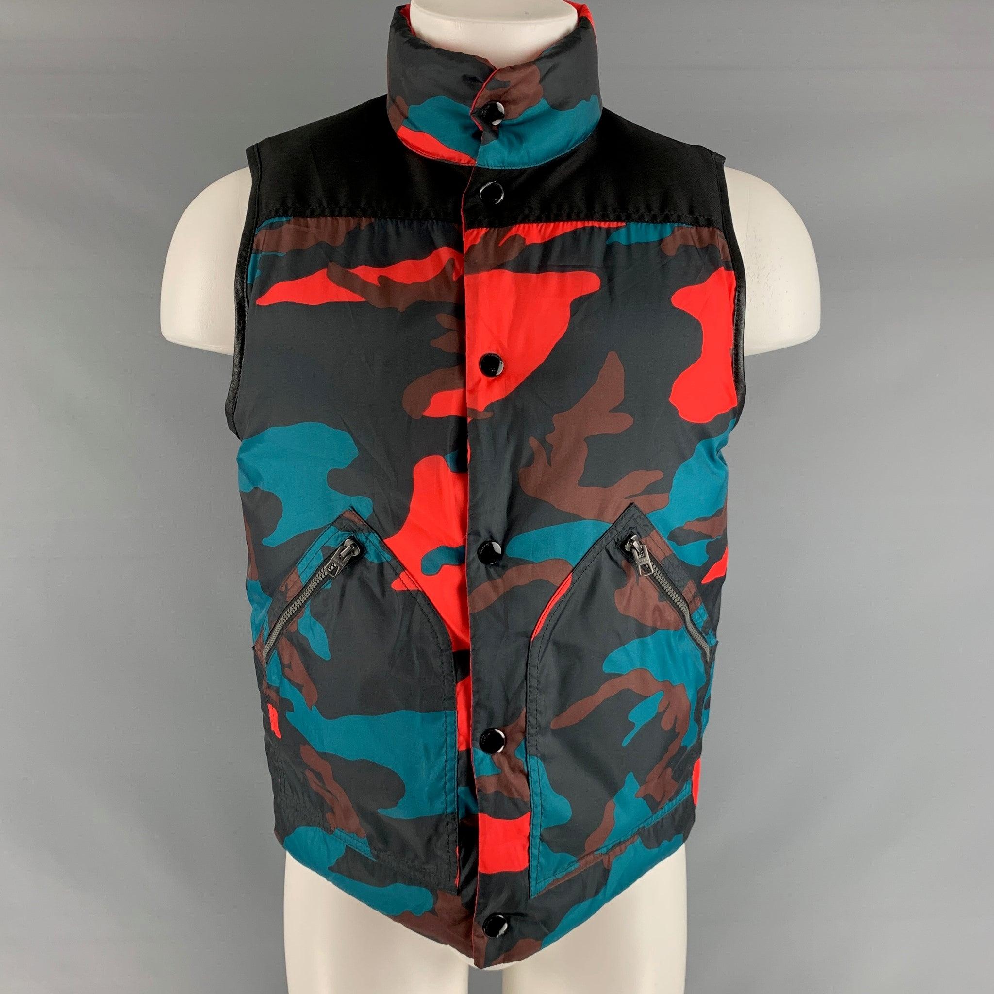 COACH vest comes in a red abd black quilted nylon woven material featuring a high collar, reversible style, sleeveless, front pockets, and a snap button closure. Excellent Pre- Owned Conditions.  

Marked:   S 

Measurements: 
 
Shoulder: 15.5