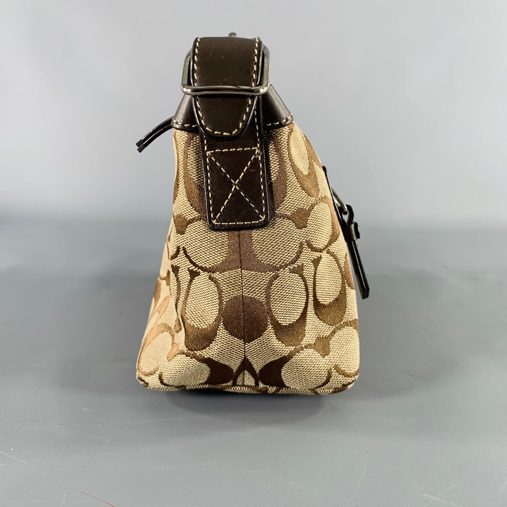 Vintage COACH handbag
in a taupe and brown fabric featuring signature monogram pattern, baguette style, and zip closure. Comes with dust bag.Very Good Pre-Owned Condition. Minor signs of wear. 

Measurements: 
  Length: 9.5 inches Width: 3.75 inches