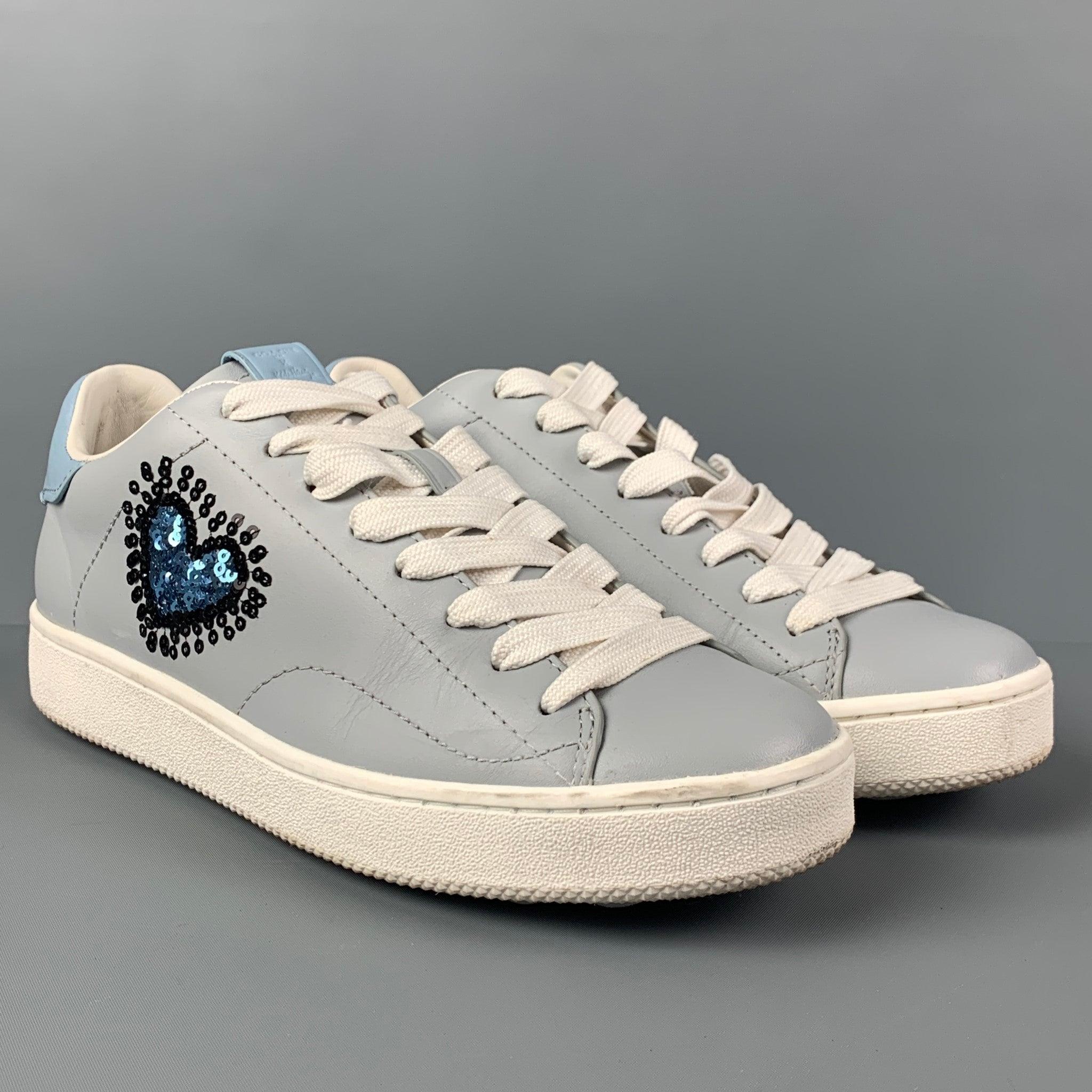 COACH x Keith Haring sneakers comes in a light blue leather featuring a low top style, sequined heart design, and a lace up closure.
Very Good
Pre-Owned Condition. Light wear at sole.  

Marked:   10 B Outsole: 11.25 inches  x 4 inches 
  
  
