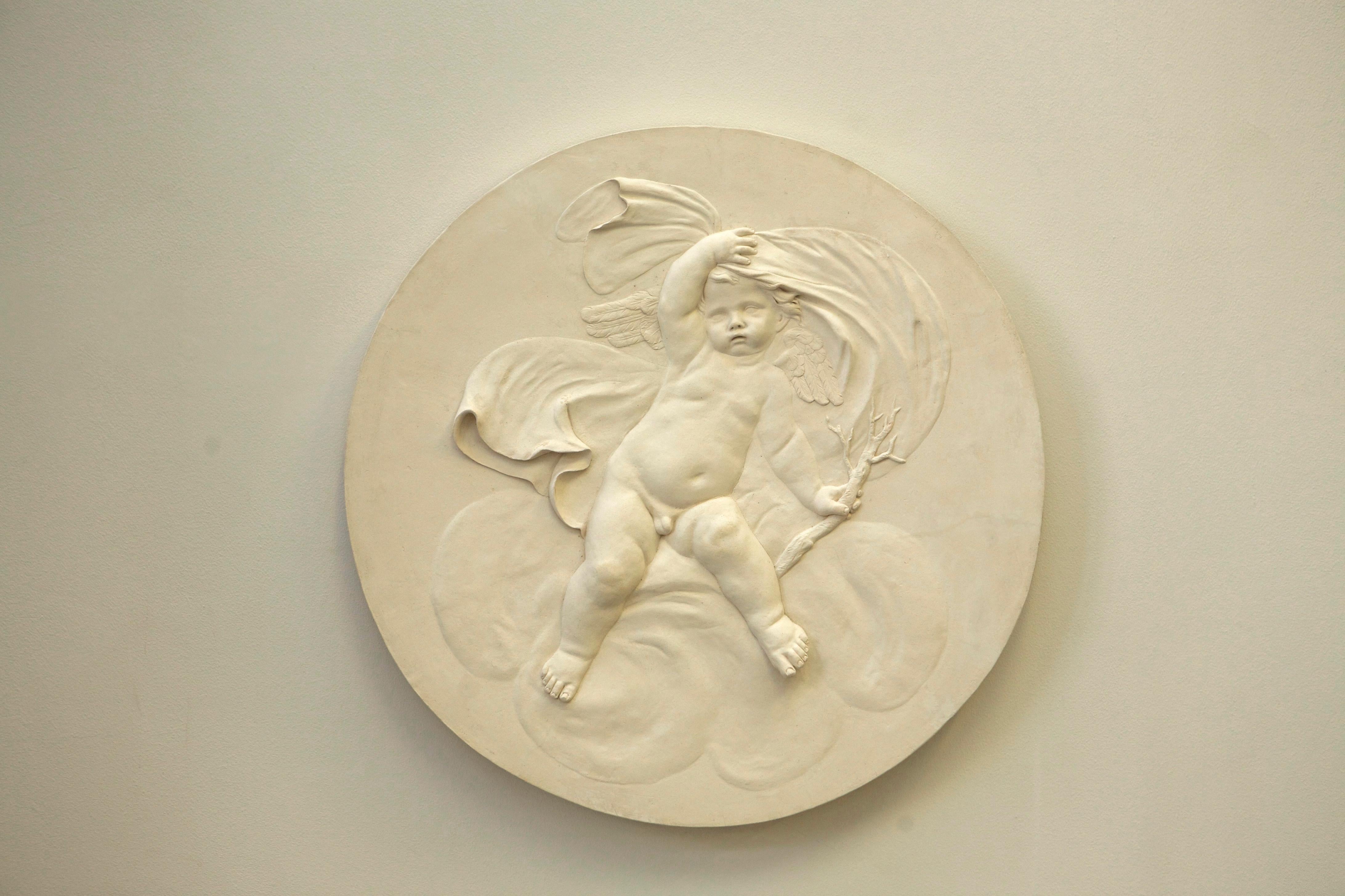 Coade Studio decorative roundel depicting 'Winter' cherub, draped and holding a bear branch/twig. Modelled in delicate low relief. The four seasons roundels are influenced by the 18th century Coade designs.

This is made from Coade Stone and is