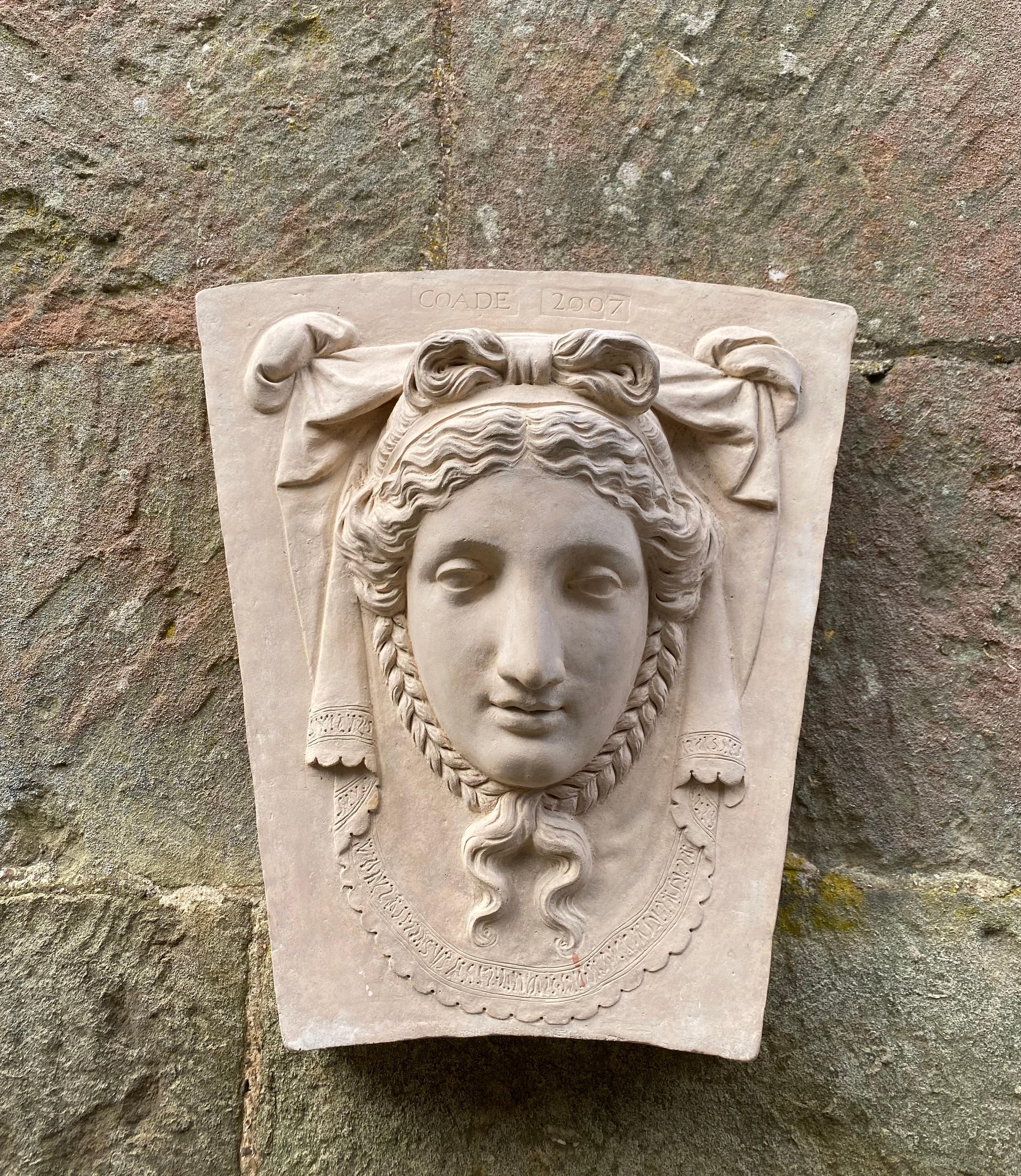 The Keystone female head draws its inspiration from an original 18th-century creation by Coade. The depiction showcases a female with plaited hair, backed by elegant drapery.

Keystones similar to this can be found adorning the tops of doors in