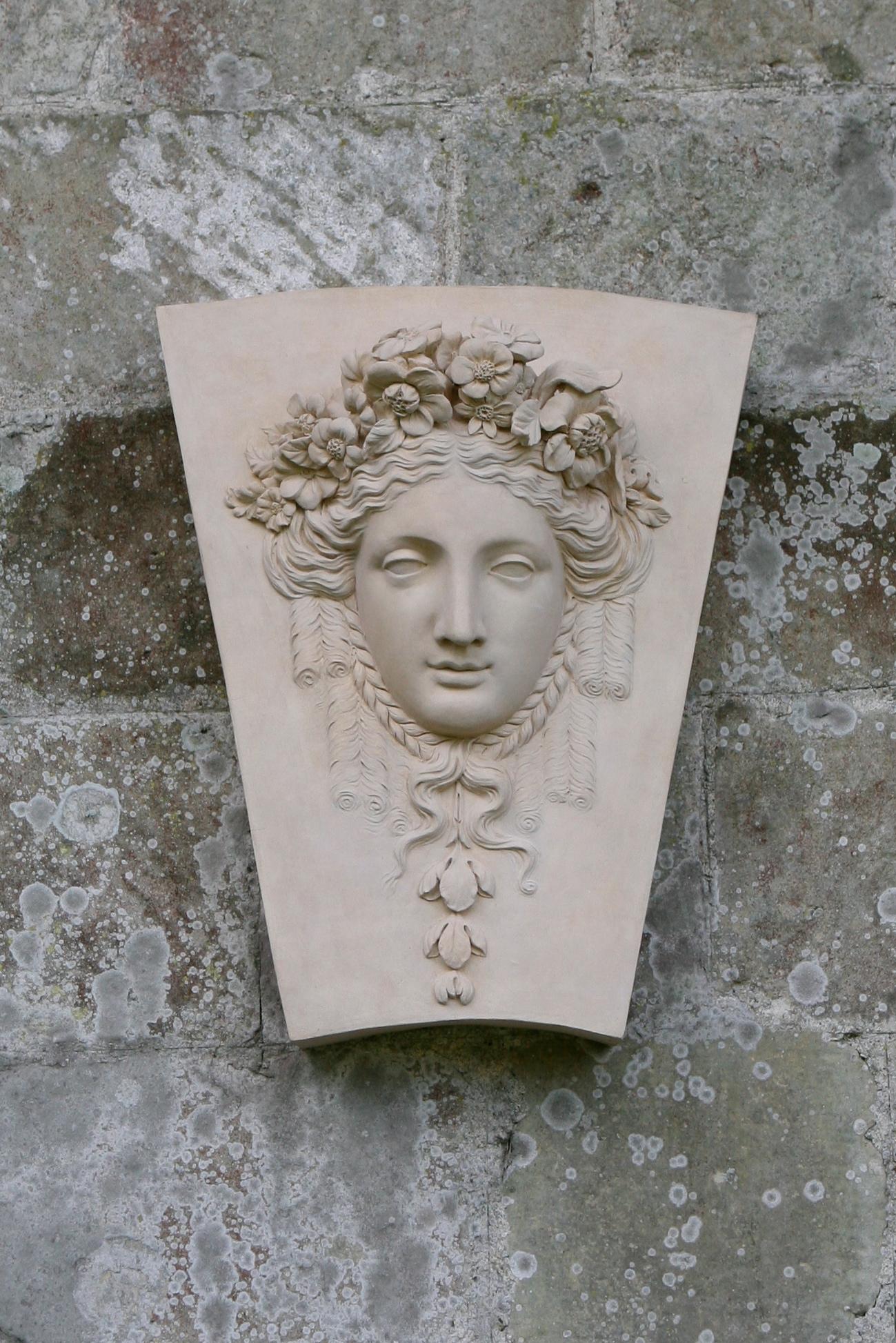 The Keystone featuring the female head of Flora draws its inspiration from an original 18th-century creation Coade. The depiction showcases Flora with plaited hair, backed by elegant drapery. Keystones similar to this can be found adorning the tops