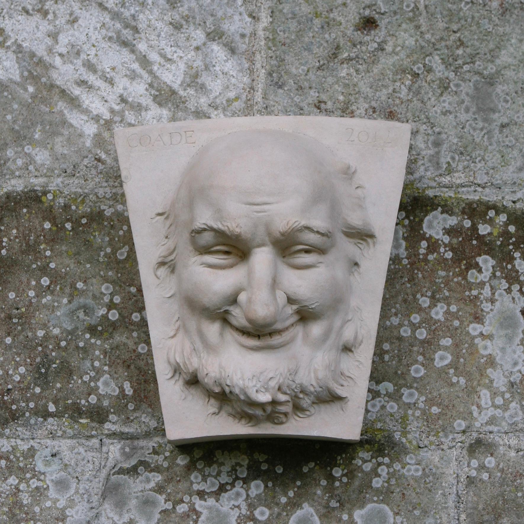 This keystone featuring a male head is a reproduction based on an original 18th-century Coade keystone.
The original keystone was purportedly inspired by the character of Harpagon from the play "The Miser," a comedic work in five acts written by the