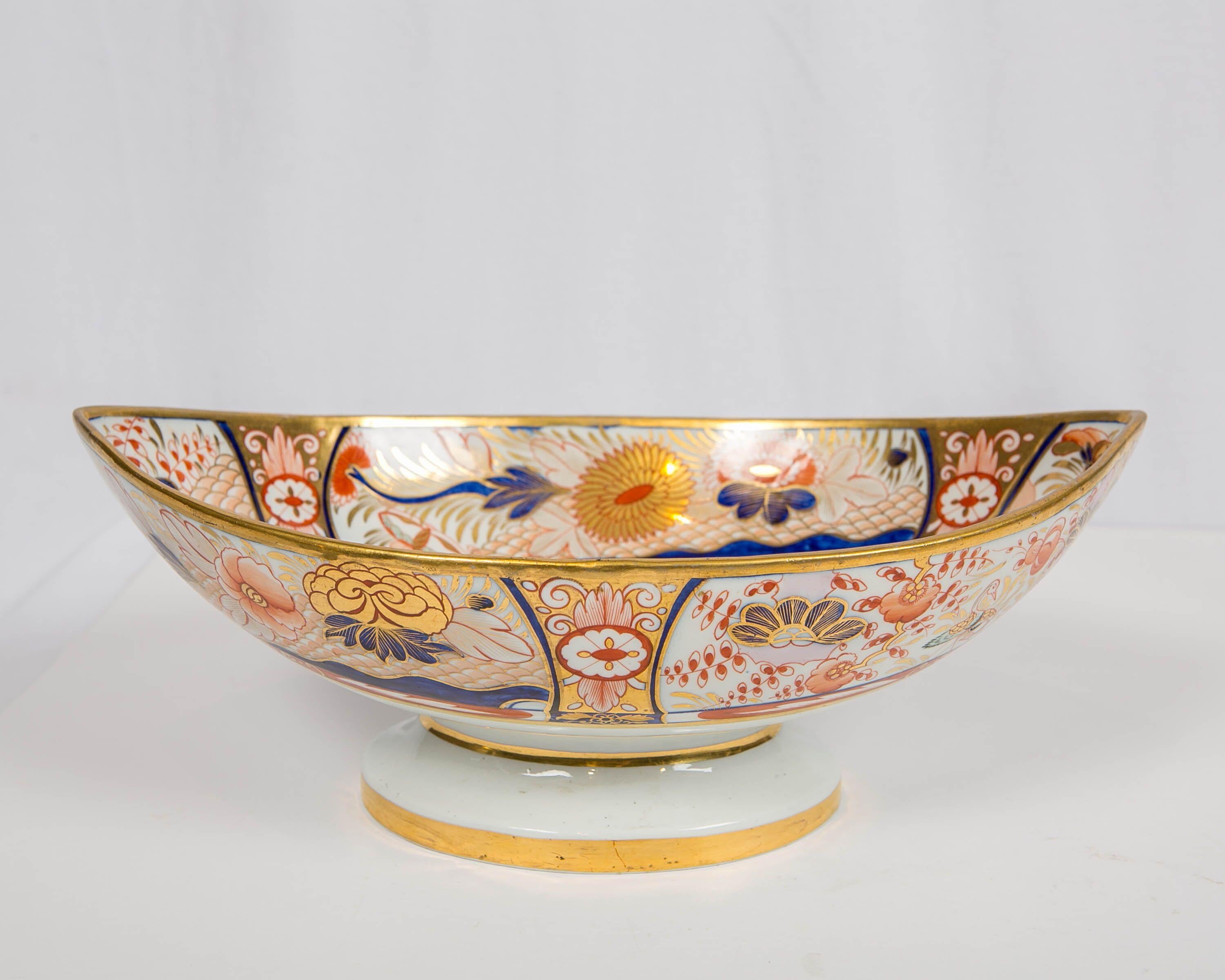 Why We Love It: The intensity of the Imari colors and the wonderful pink spotted lion.
This Coalport Admiral Nelson pattern centerpiece was hand-painted in England during the Regency period circa 1810. Richly gilded and painted in cobalt blue and