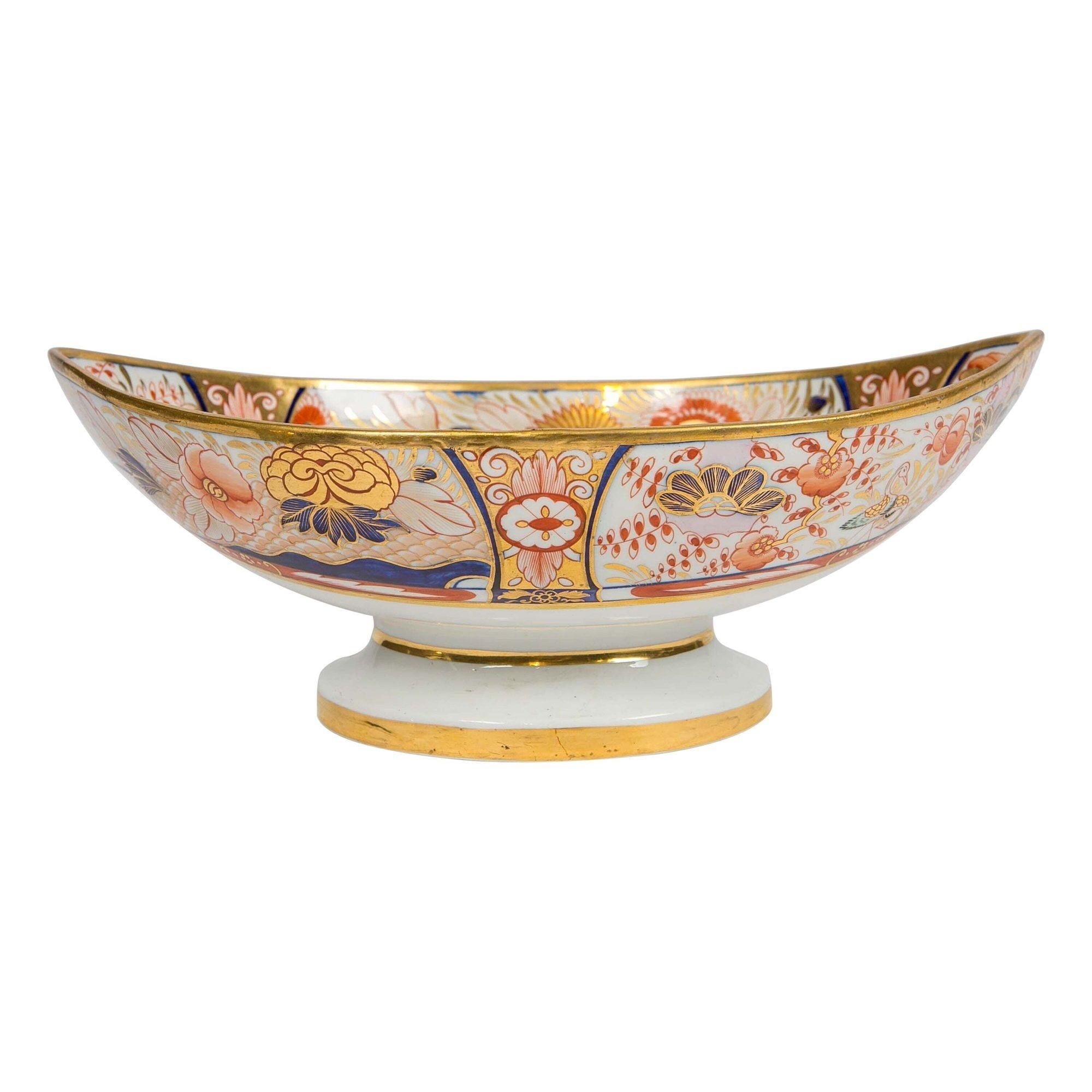 Why We Love It: The intensity of the Imari colors.
This Coalport Admiral Nelson pattern centerpiece was hand-painted in England during the Regency period circa 1810. Richly gilded and painted in cobalt blue and iron red, it is decorated in a