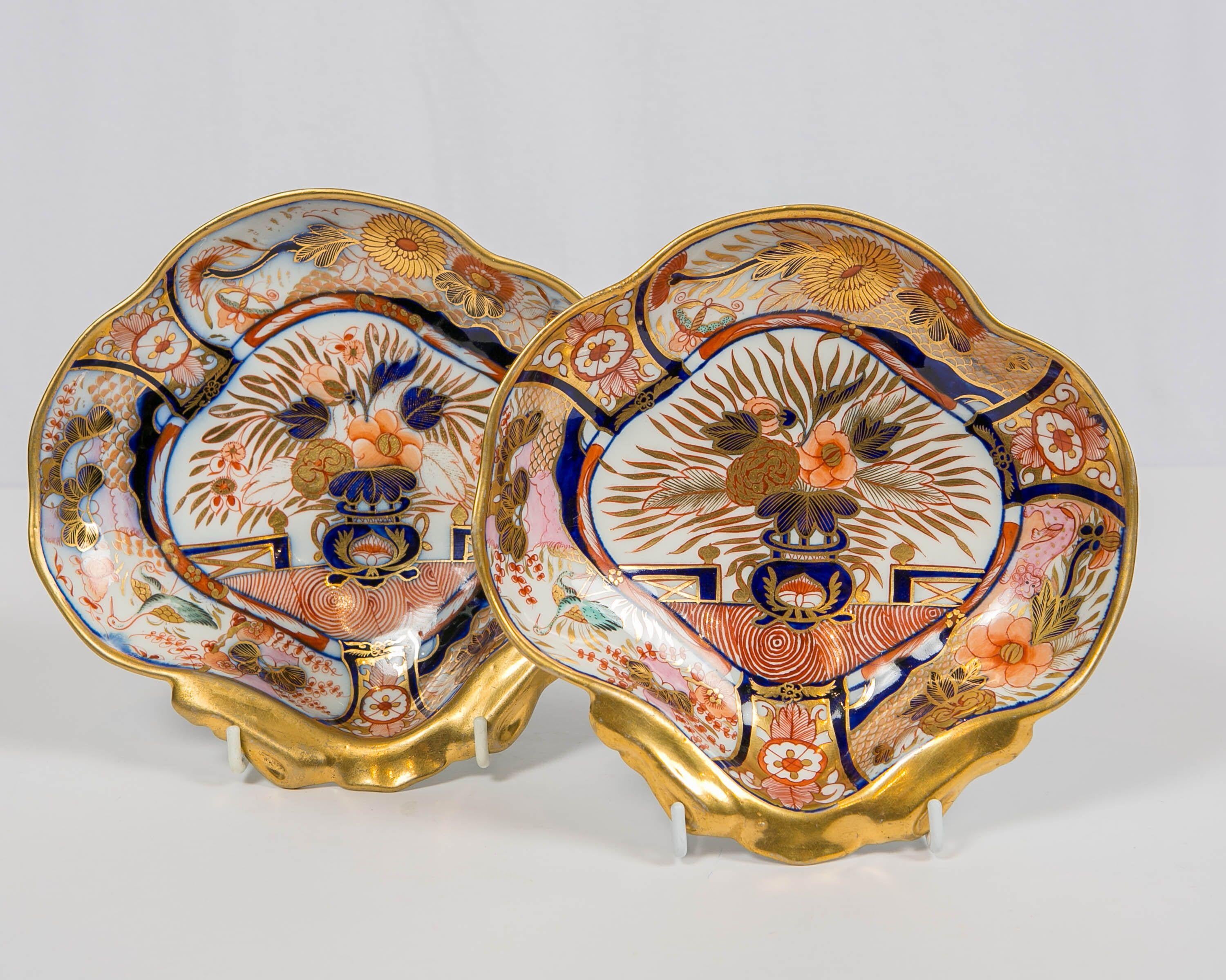 Why We Love It:
The intensity of the Imari colors and the wonderful pink spotted lion.
This pair of Coalport Admiral Nelson shell shaped dishes was hand painted in England during the Regency period, circa 1810. They are decorated in a traditional,