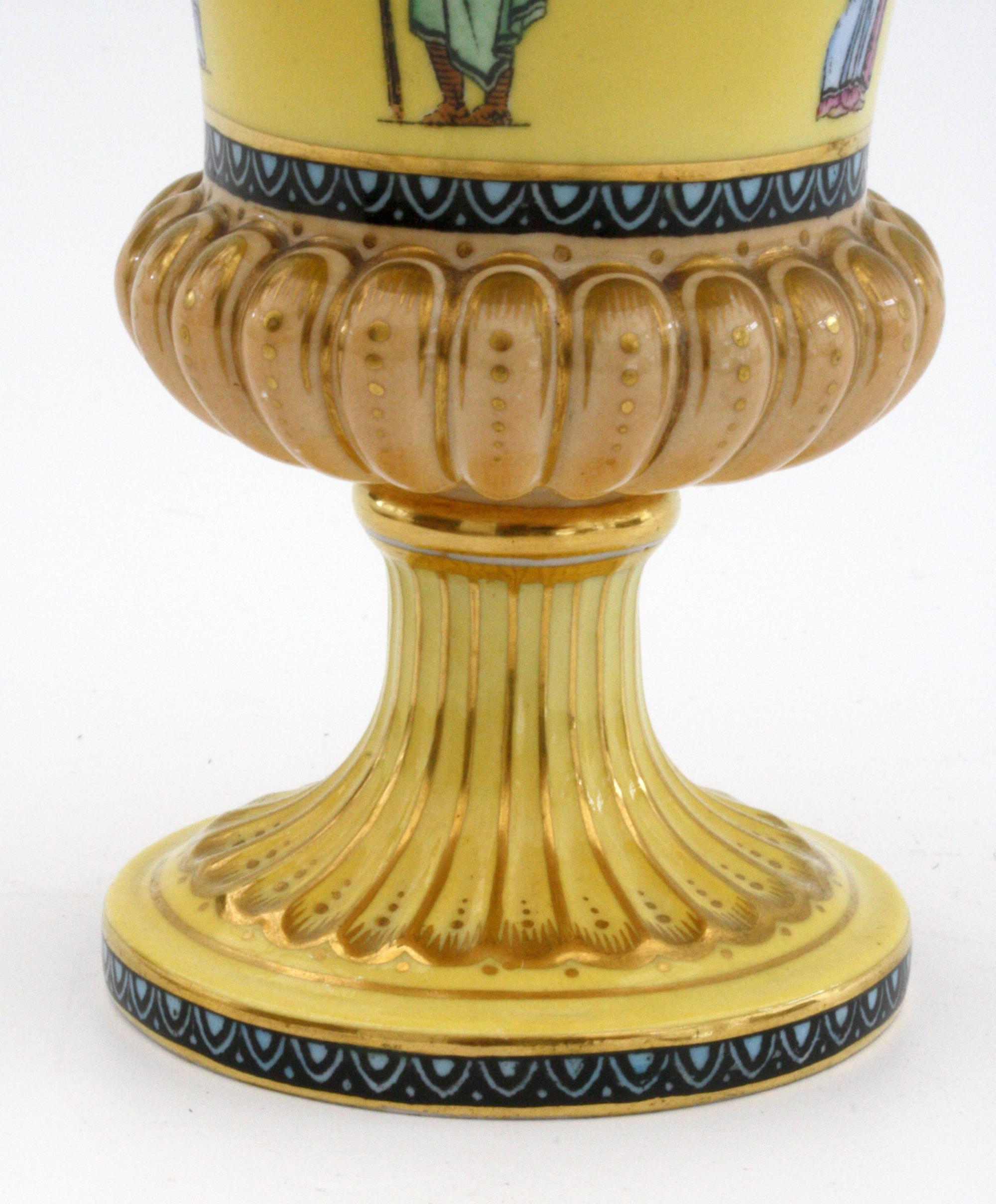 A stunning and well painted antique Coalport campana shape porcelain vase decorated with classical figures on a yellow ground and dating from circa 1895. The vase stands on a rounded base with scalloped moulding to the stem with a decorative top