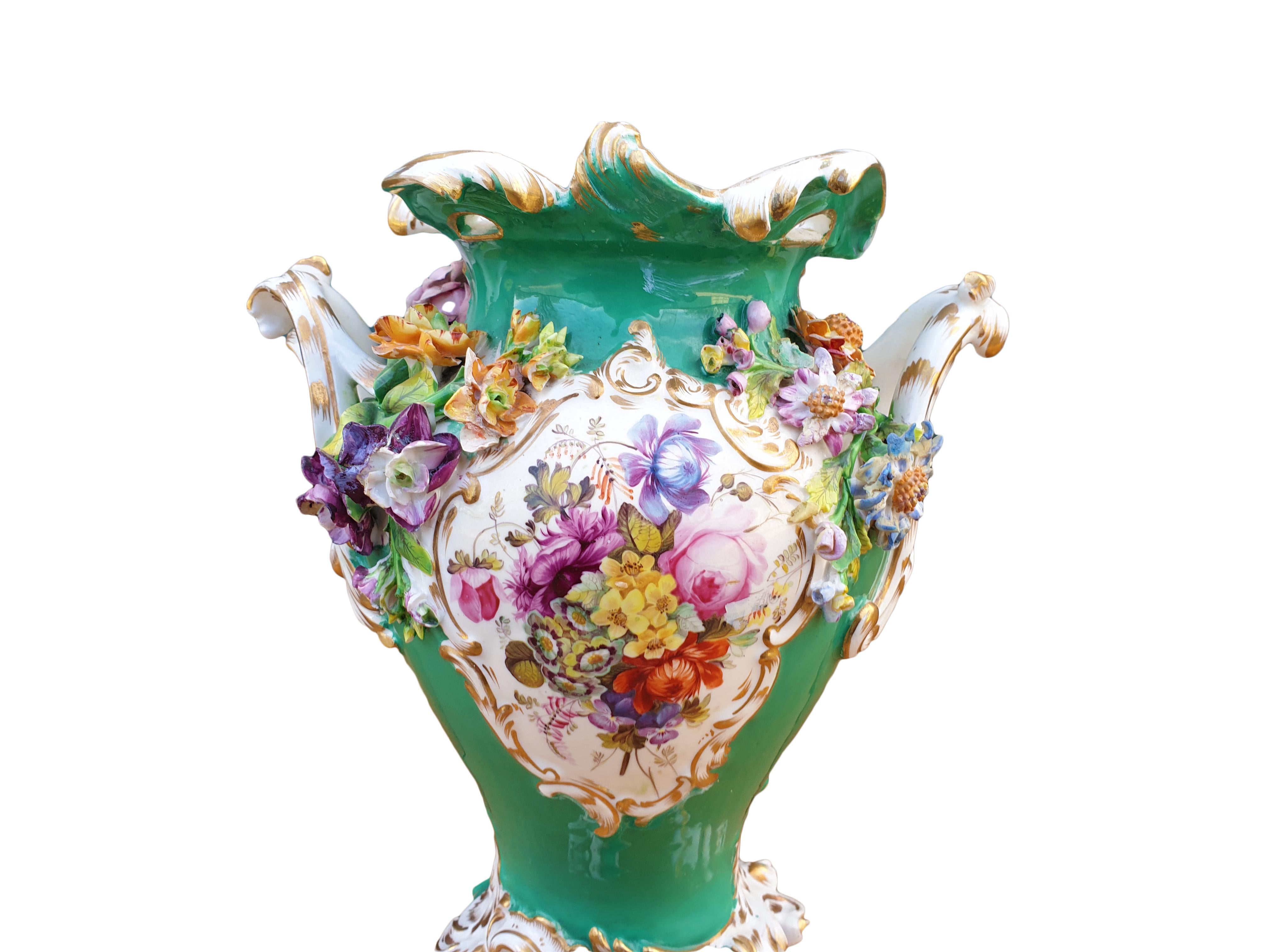 A lovely Coalport Green single Vase with Encrusted flowers and a feast of Handpainted garden flowers in the middle, the seasons all mixed in a kaleidoscope of colors. The encrusted flowers comes in varying sizes while the bigger ones has a diameter