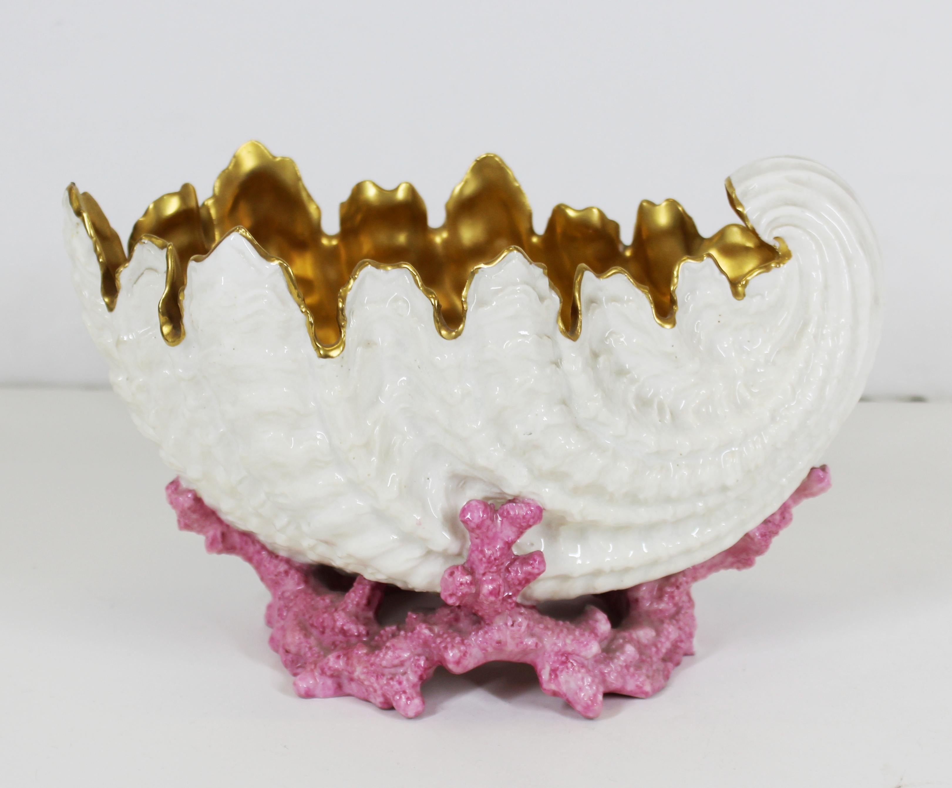 Coalport English porcelain nautilus shell bowl with gilt interior, atop pink coral stand. Makers mark on bottom. In great antique condition with age-appropriate wear and small chip to coral.