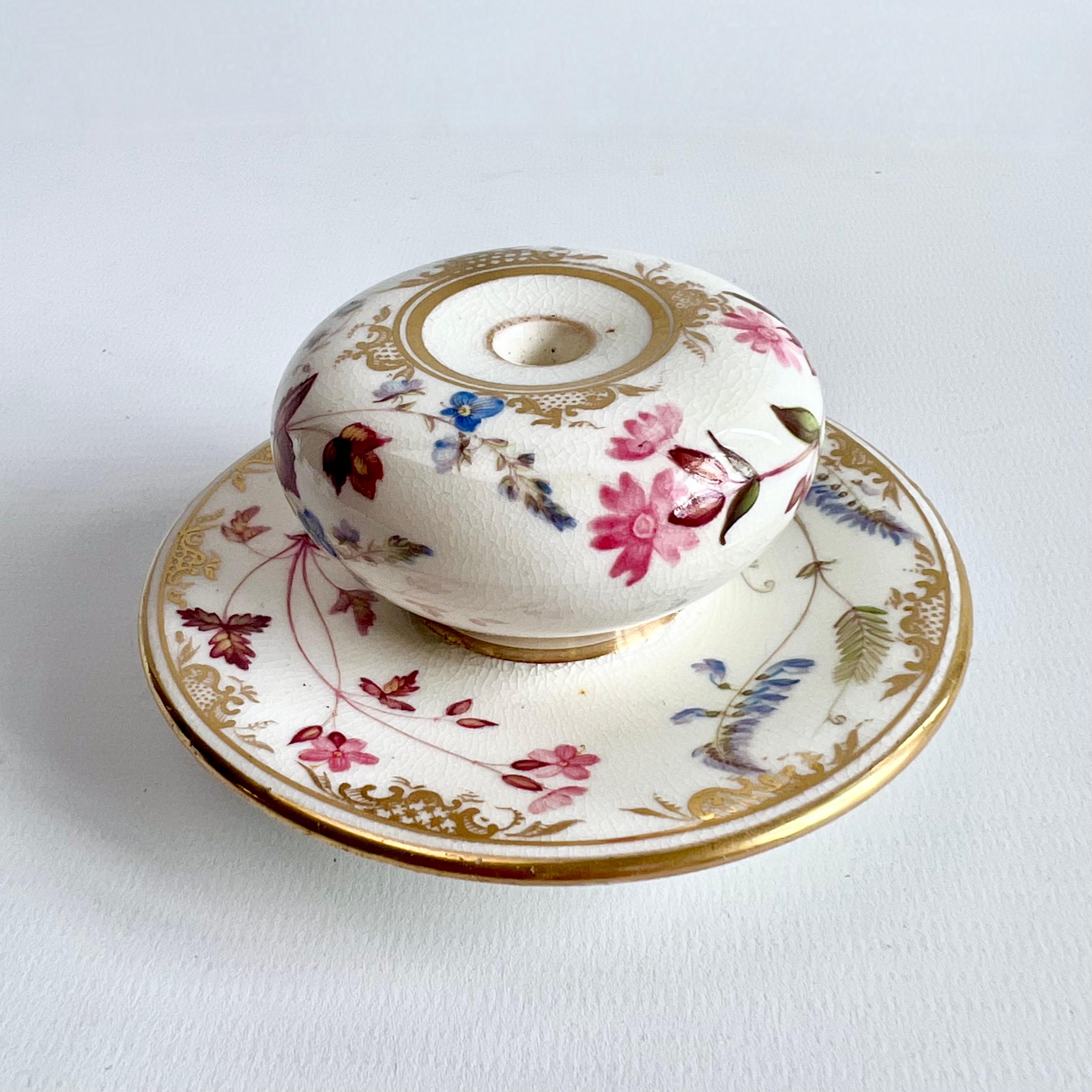 This is a beautiful inkwell made by Coalport in about 1820, which was the Regency era. It is decorated with beautiful flowers in the manner of William Pollard.

We also have a teacup and saucer in the same pattern, please see image and separate