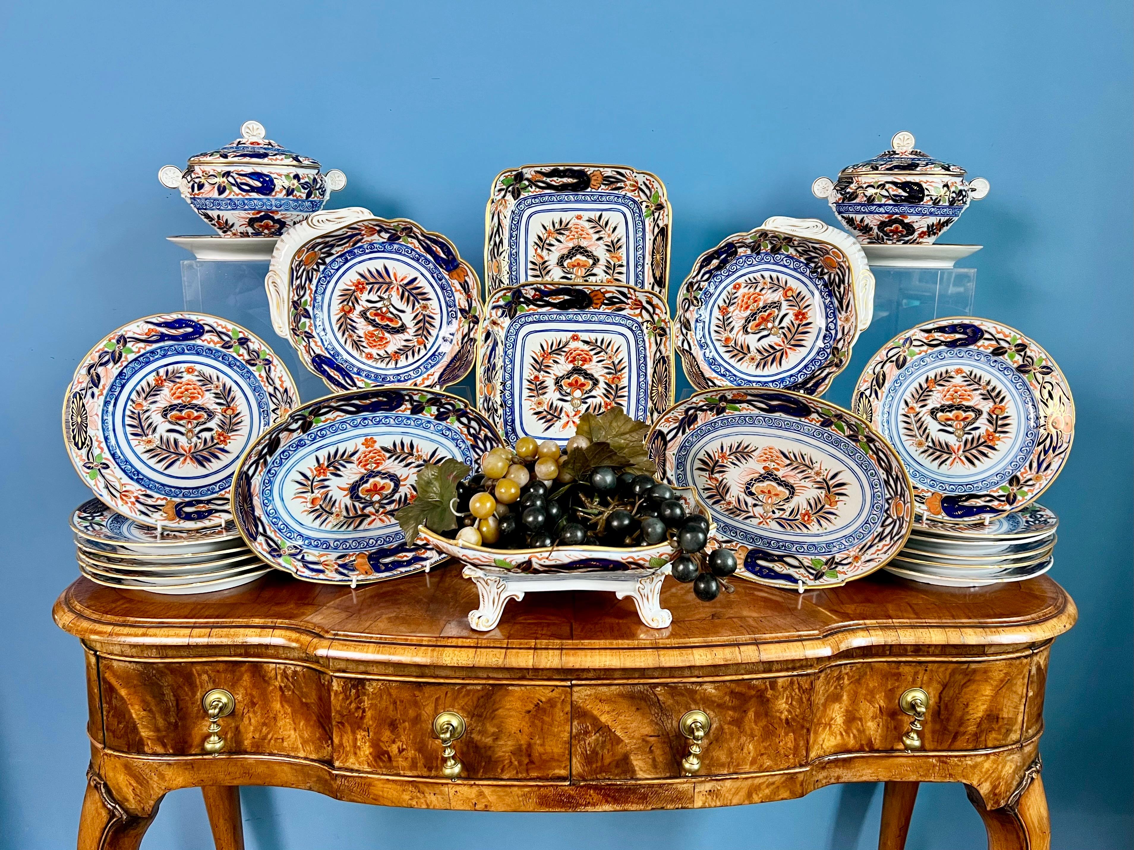 This is a rather stunning 25-piece dessert service made by John Rose at Coalport around the year 1805. It consists a centre piece on four feet, two oval dishes, two shell dishes, two square dishes, two sauce tureens with covers and stands, and