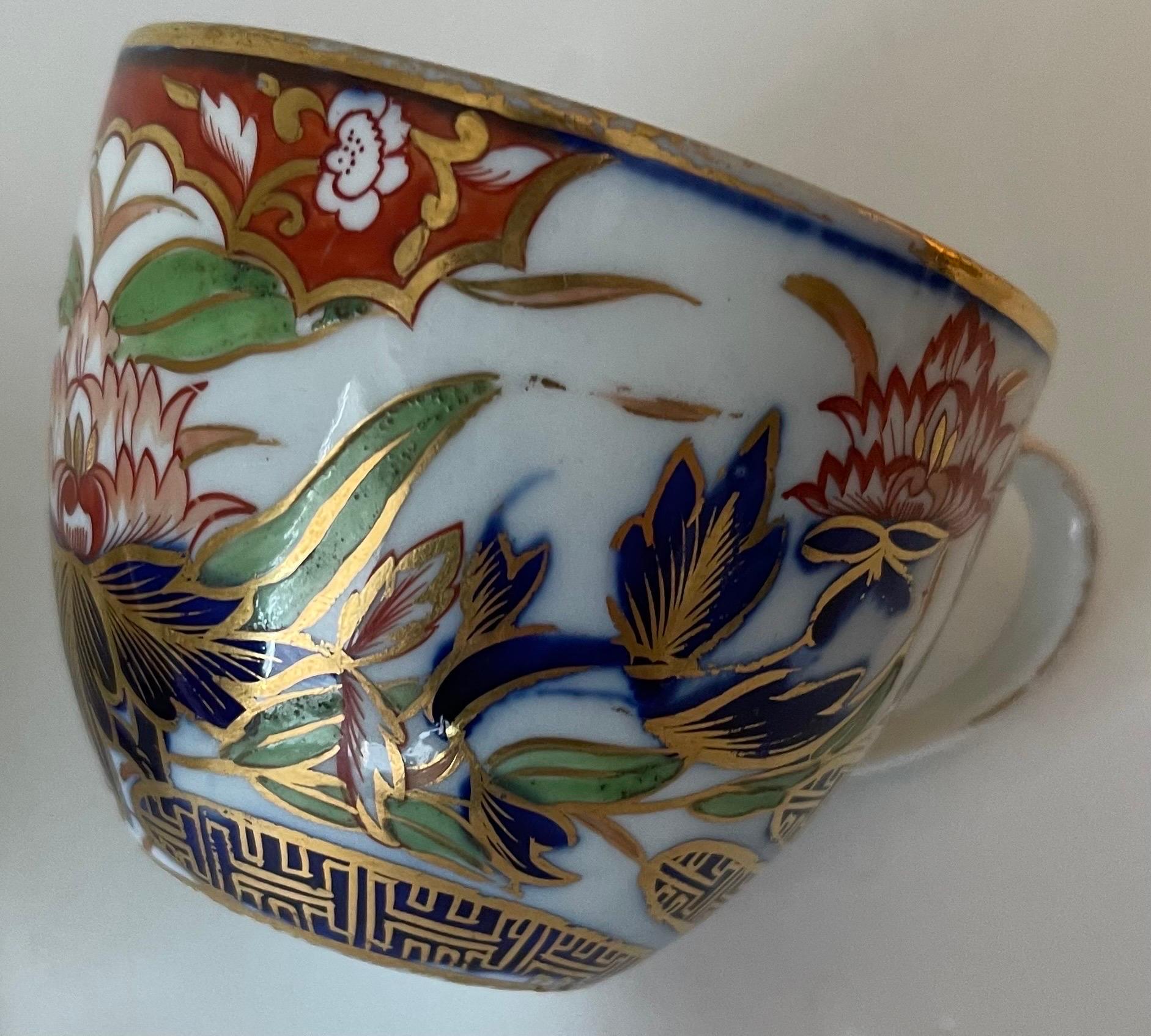 Early 1800s Coalport John Rose Thumb and Finger teacup and saucer: Hand painted, richly colored and detailed cup and saucer with hand painted gold band. No makers mark or signature. 
Cup measures: 4” wide x 3” tall. Saucer measures 5.5” wide