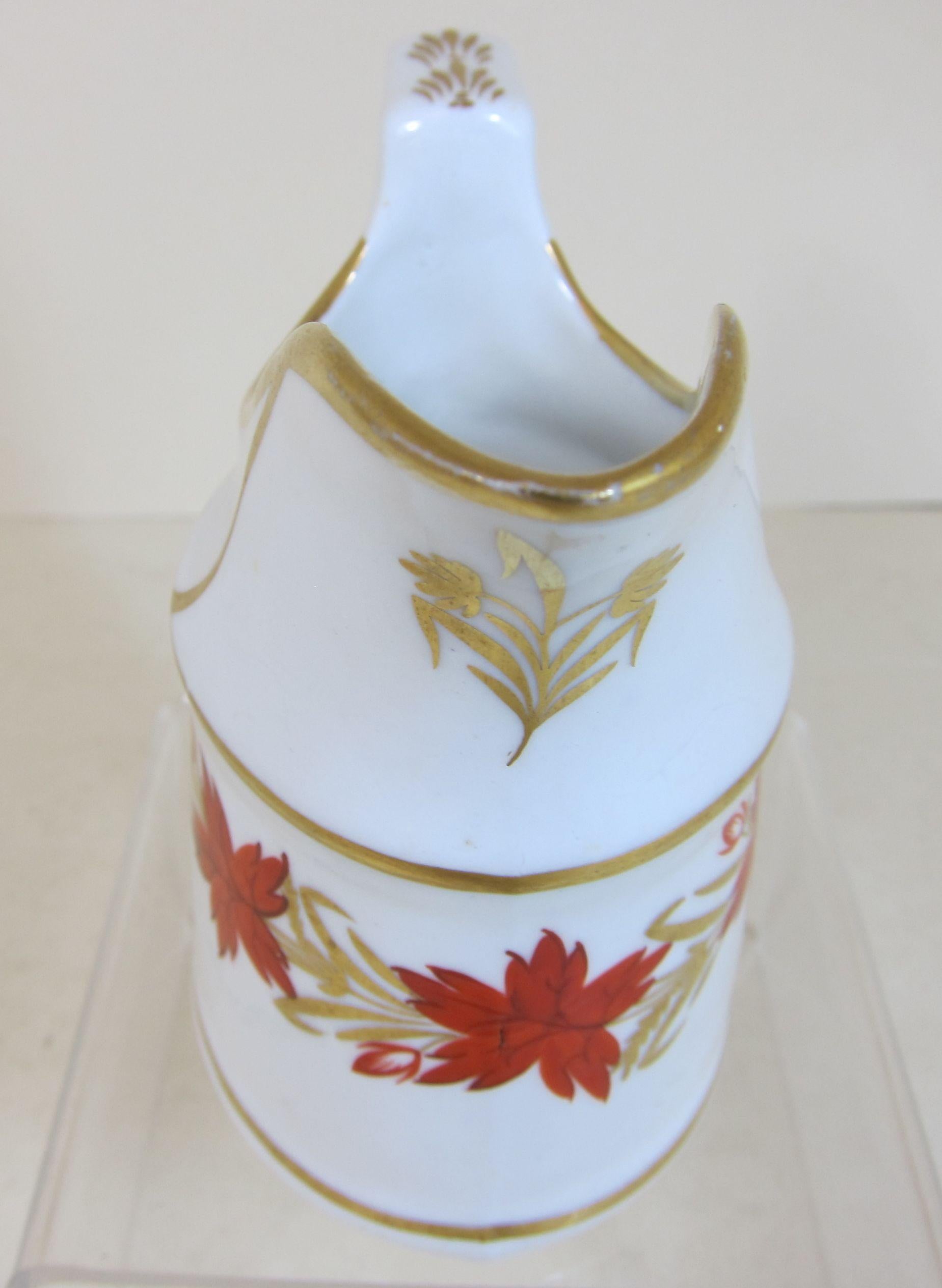 Coalport Porcelain creamer decorated with red and gilt flowers.