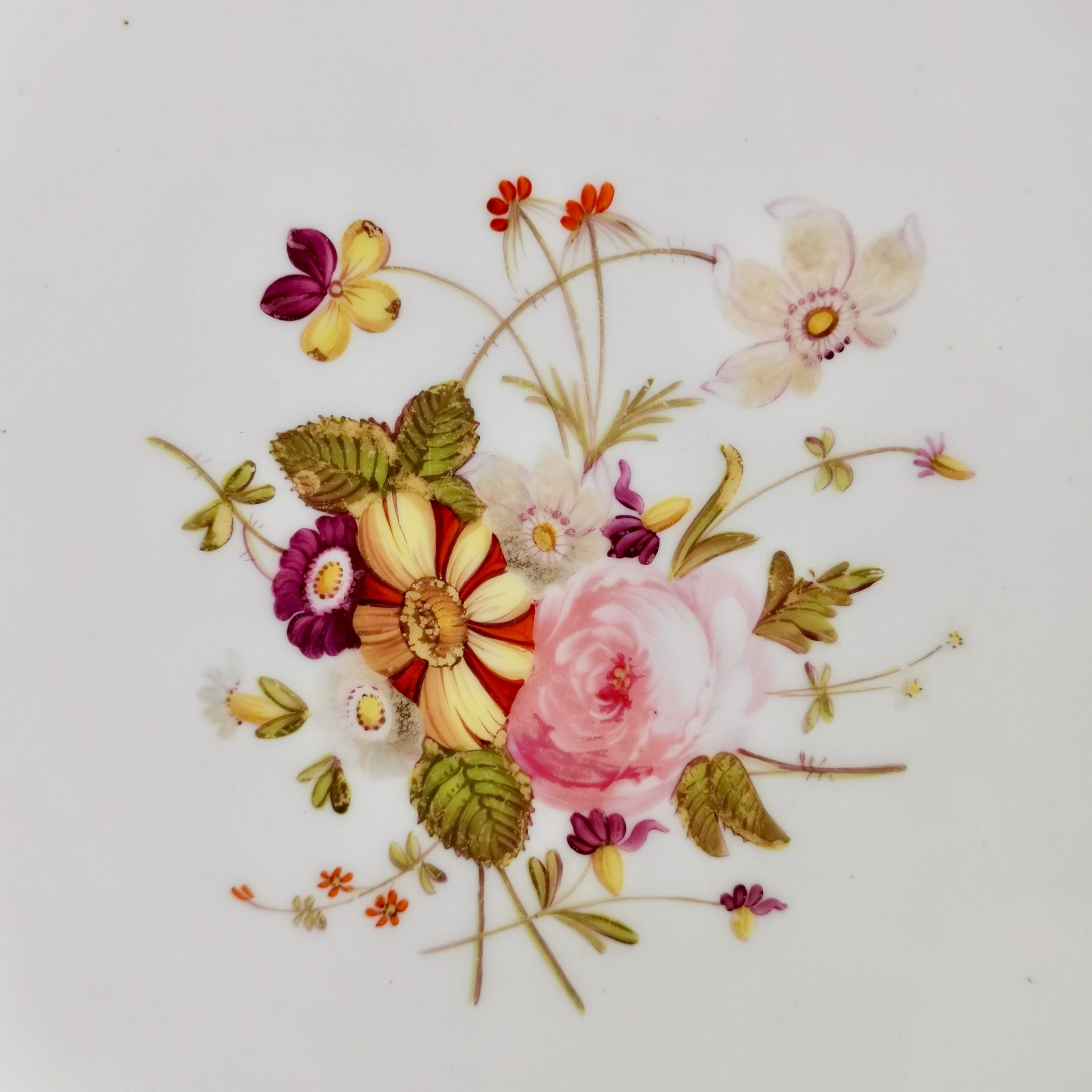 This is a beautiful dessert plate made by Coalport in 1827, which was the Regency era. The plate has a beautifully moulded rim, a bright blue ground and hand painted flower reserves.

Coalport was one of the leading potters in 19th and 20th