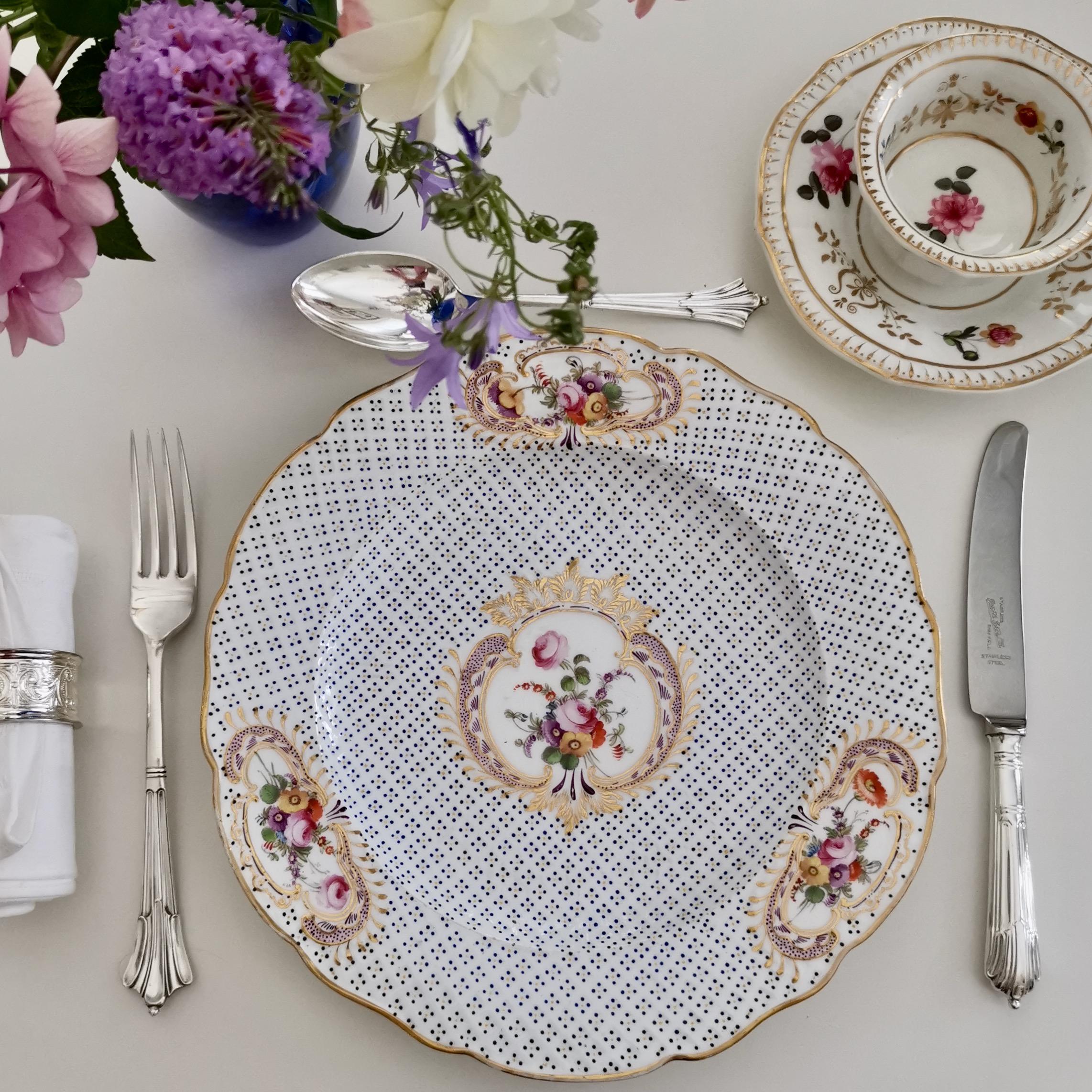 This is a wonderful Coalport dinner plate made in circa 1820, which is known as the Regency period. The plate has moulding all-over the surface, as well as gilded reserves with beautiful hand painted flowers.

Coalport was one of the leading