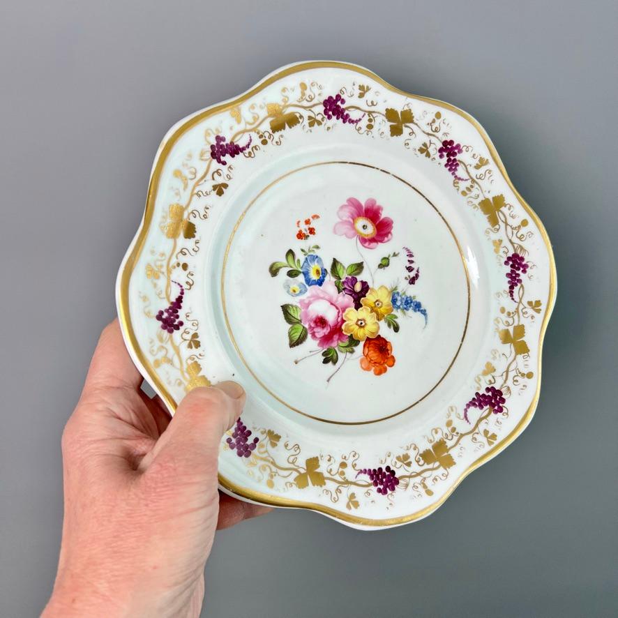 This is a beautiful plate made by Coalport around the year 1820. The plate is decorated in white with a simple gilt rim, darting puce and gilt vines, and a wonderful hand painted bouquet of summer flowers in the centre.

Coalport was one of the