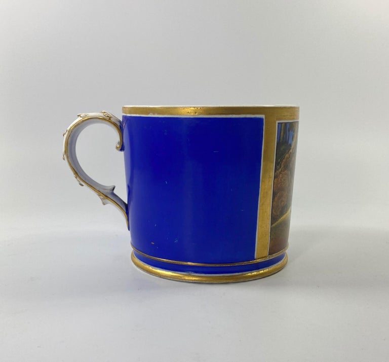 A fine and rare Coalport porcelain Porter Mug, dated 1820. The large mug with a blue ground, and finely painted by John Holmes Smith, with a scene of a man hunting deer, in an extensive landscape, within a gilt panel.
Having an acanthus leaf