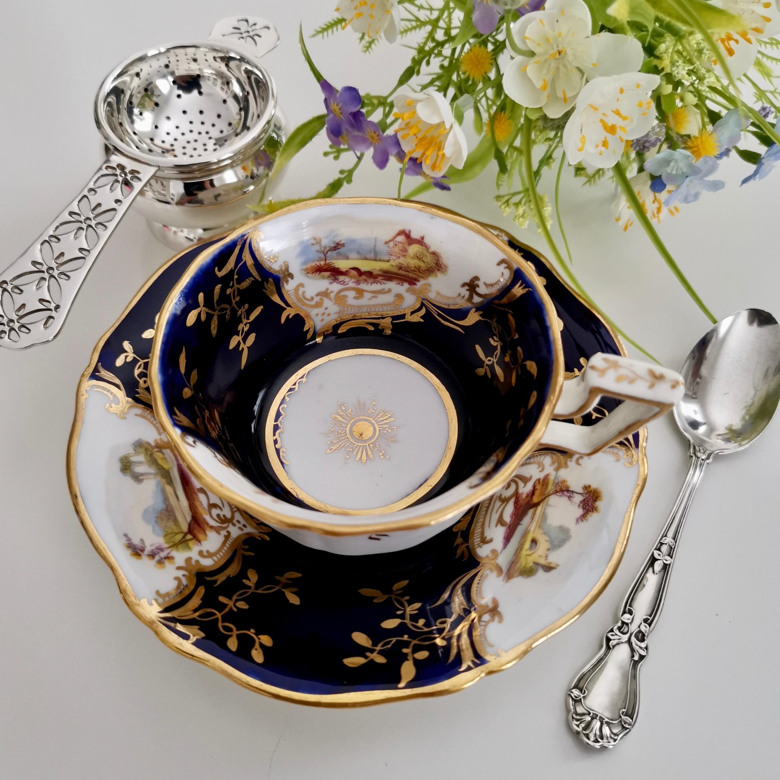 This is a beautiful teacup and saucer made by Coalport in circa 1823, which is known as the Regency period. The set is made in the famous fluted shape with an 