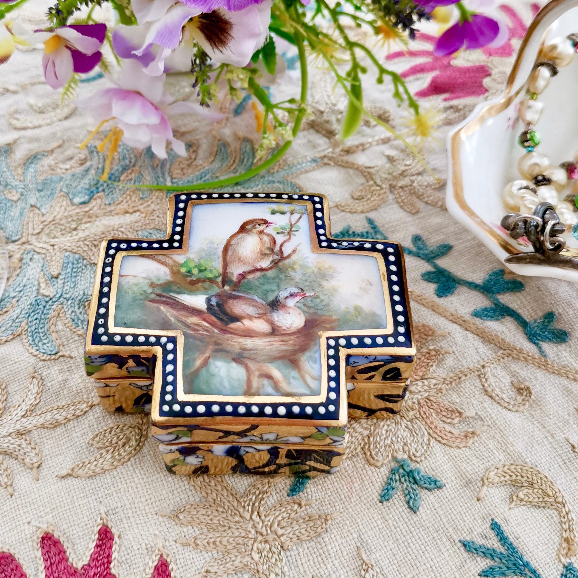 This is a beautiful and rare trinket box made by Coalport probably between 1865 and 1870. It was painted with birds on their nest by the famous porcelain bird painter John Randall, and it is an exceptionally beautiful example of Randall's style in