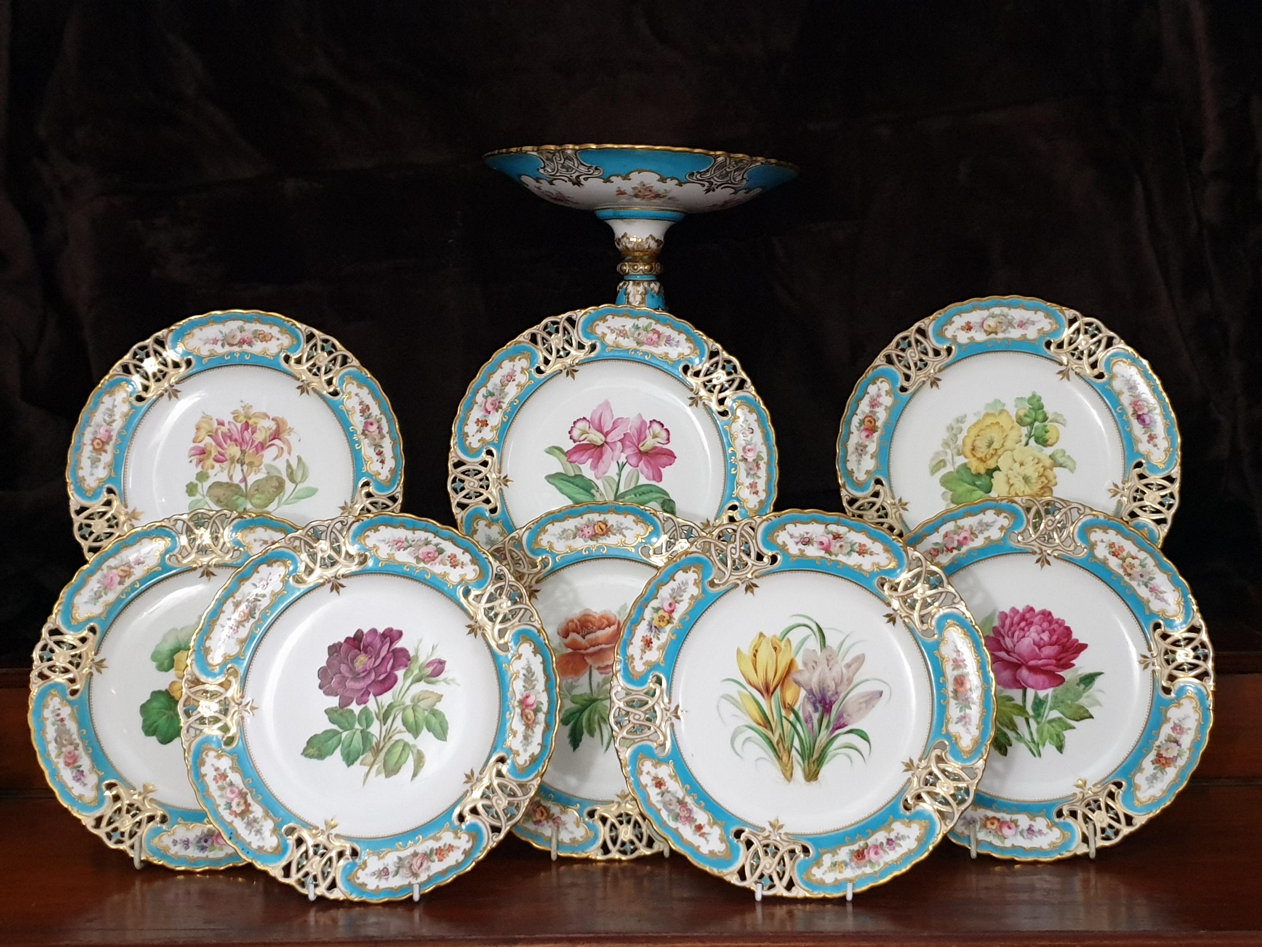 Minton reticulated exceptional botanical turquoise dessert service for 8 with comport. Reticulated in the shape of royal arms each plate individually hand painted with a different floral specimen to the center with reticulated turquoise enameled
