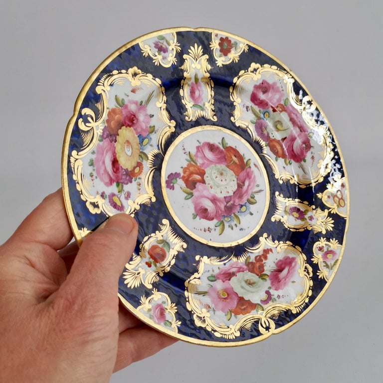 This is a beautiful small plate made by Coalport between 1810 and 1815. The plate has a deep cobalt blue scaled ground and flower reserves surrounded by gilt scrolls.

Coalport was one of the leading potters in 19th and 20th Century Staffordshire.