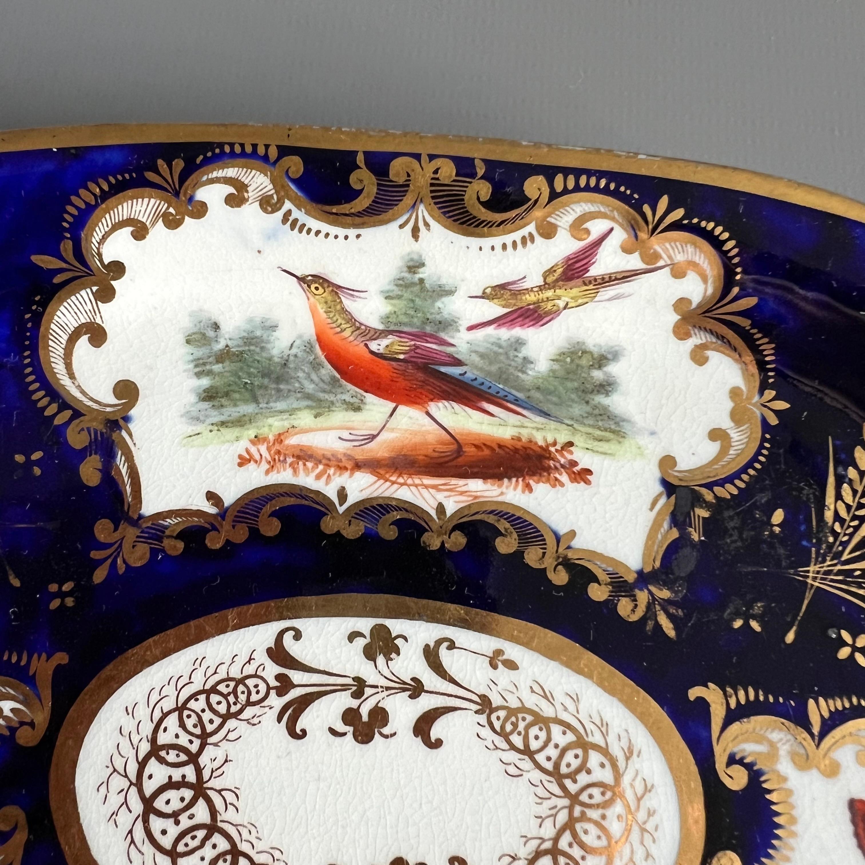 This is a beautiful teapot stand or small rectangular dish made by Coalport around the year 1815. This stand would have belonged to a large tea service. The stand is decorated with a deep cobalt blue ground, elegant gilding and beautifully hand