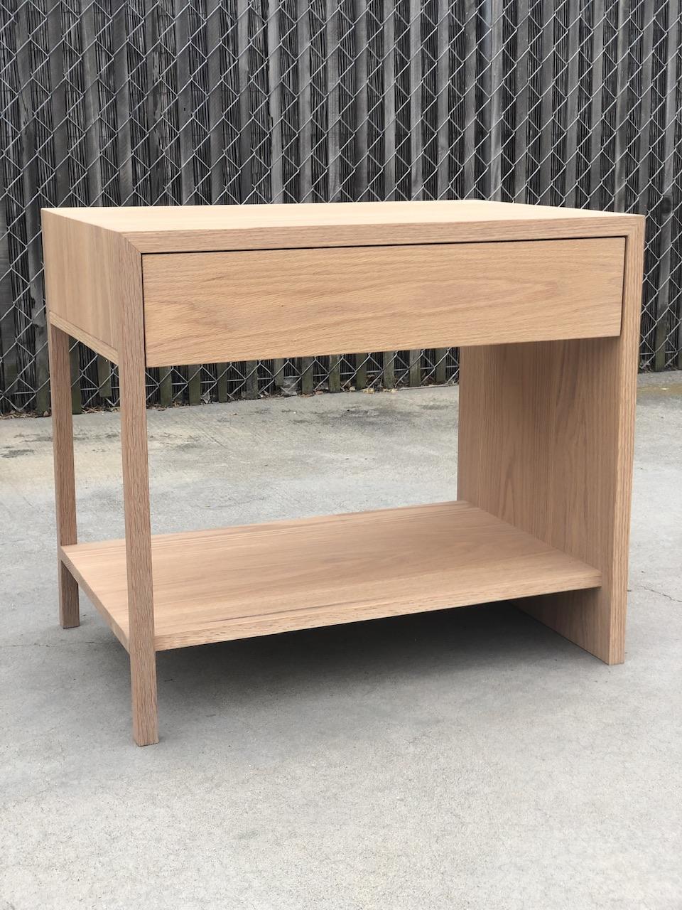 COAST  nightstand made out of Red Oak
  
Solid Oak case and drawer fronts. If purchasing as a set, additional nightsand can be made in mirror image. Solid drawer boxes with finger joint joinery. Hand made, mortise & tenon joinery. Blum Tandem under