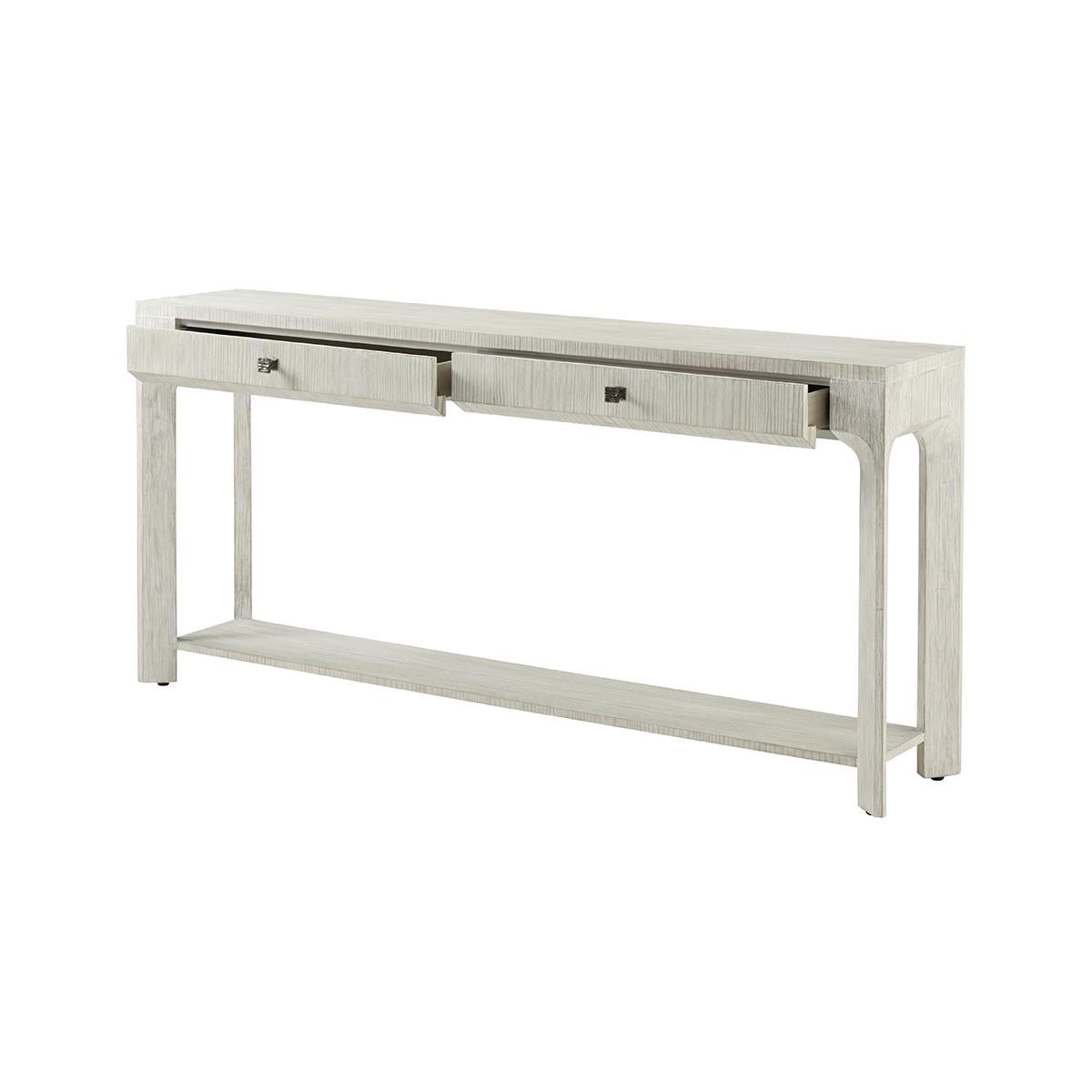 Console Table is crafted from wire-brushed cerused pine and coated in our Sea Salt finish. With a beveled-shaped cross section, dual drawers, and a lower display shelf.

Dimensions: 72