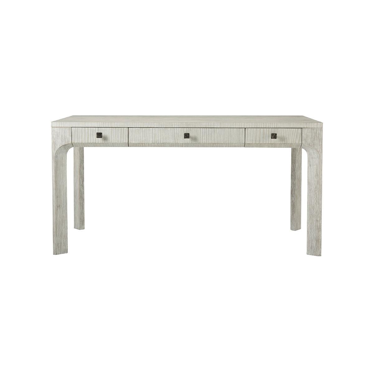 handcrafted wire-brushed cerused pine in a light and subdued Sea Salt finish, the desk displays three functional drawers with organic ribbed metal knobs in our Dark Sterling finish and a beveled-shaped cross-section.

Dimensions: 60