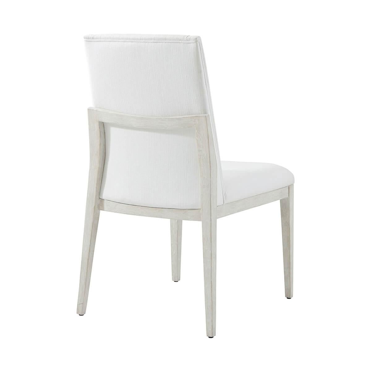 In our Sea Salt finish, the upholstered side chair displays a comfortable upholstered seat with a fully upholstered back. Raised on square tapered legs.

Dimensions: 21.25