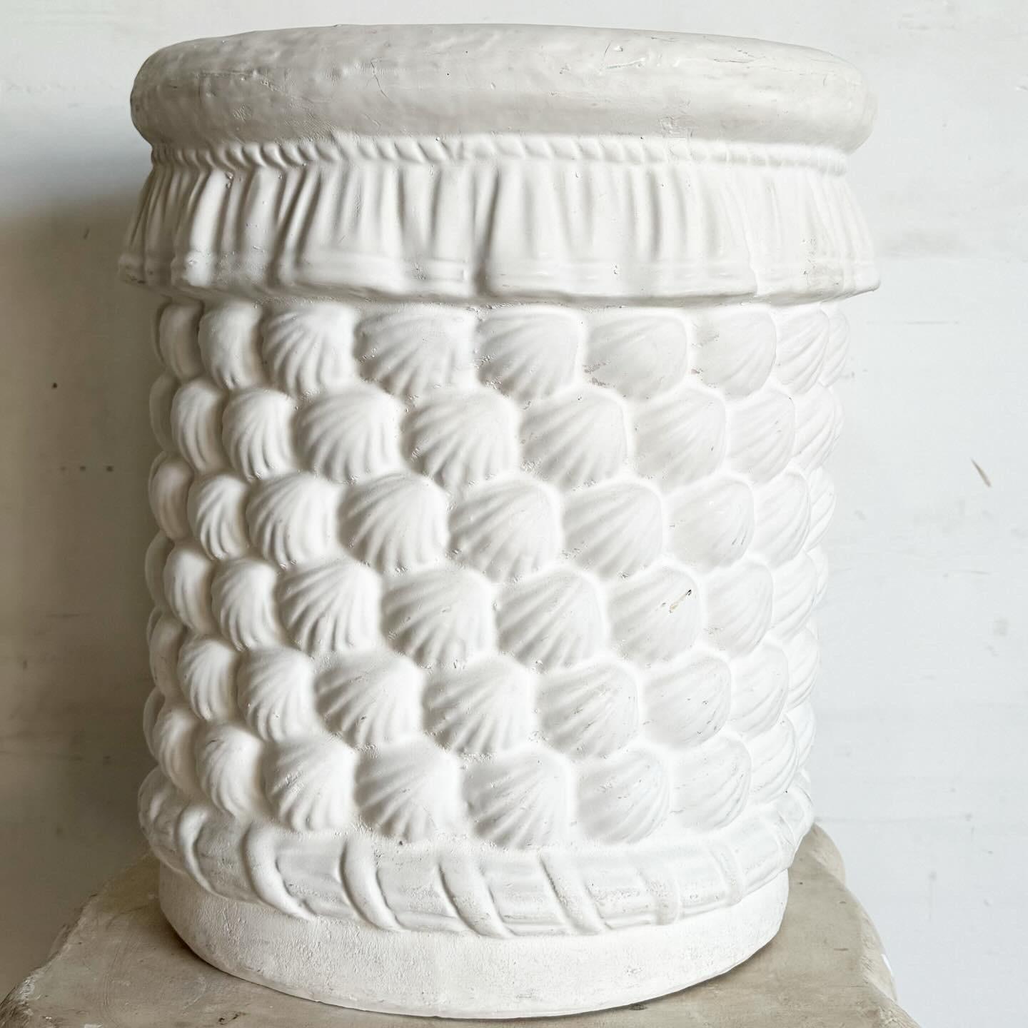 Bring the serene charm of the seaside to your home with the Coastal Ceramic Seashell Side Table/Pedestal. This beautifully crafted piece combines the elegance of coastal design with the durability of ceramic, featuring a sculpted seashell motif that