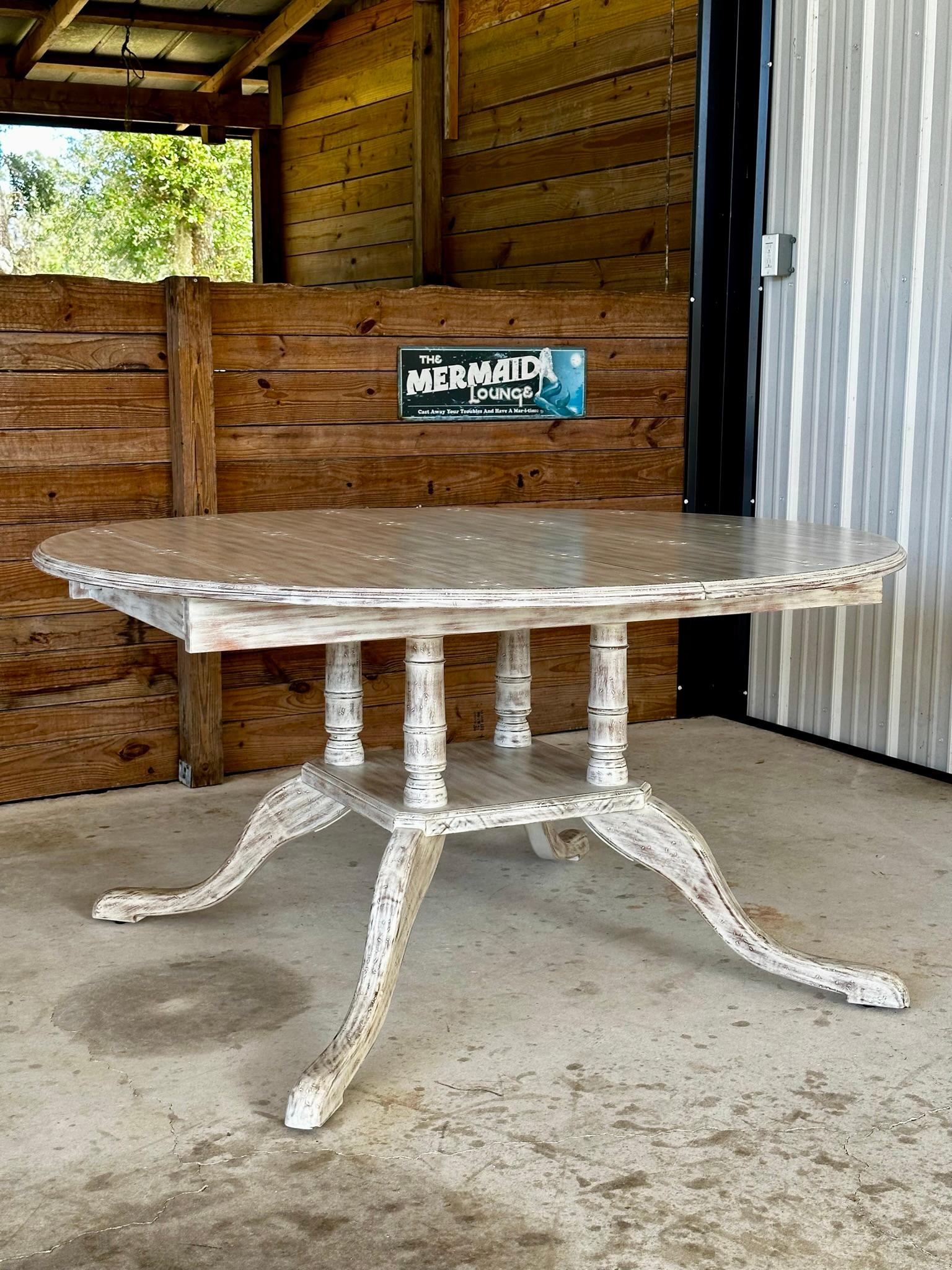 
Certainly! Here’s an expanded and rewritten version of the paragraph:

Introducing a stunning coastal white distressed extendable dining table, custom made by Modern History Home Furniture for the previous homeowner. This exquisite table features