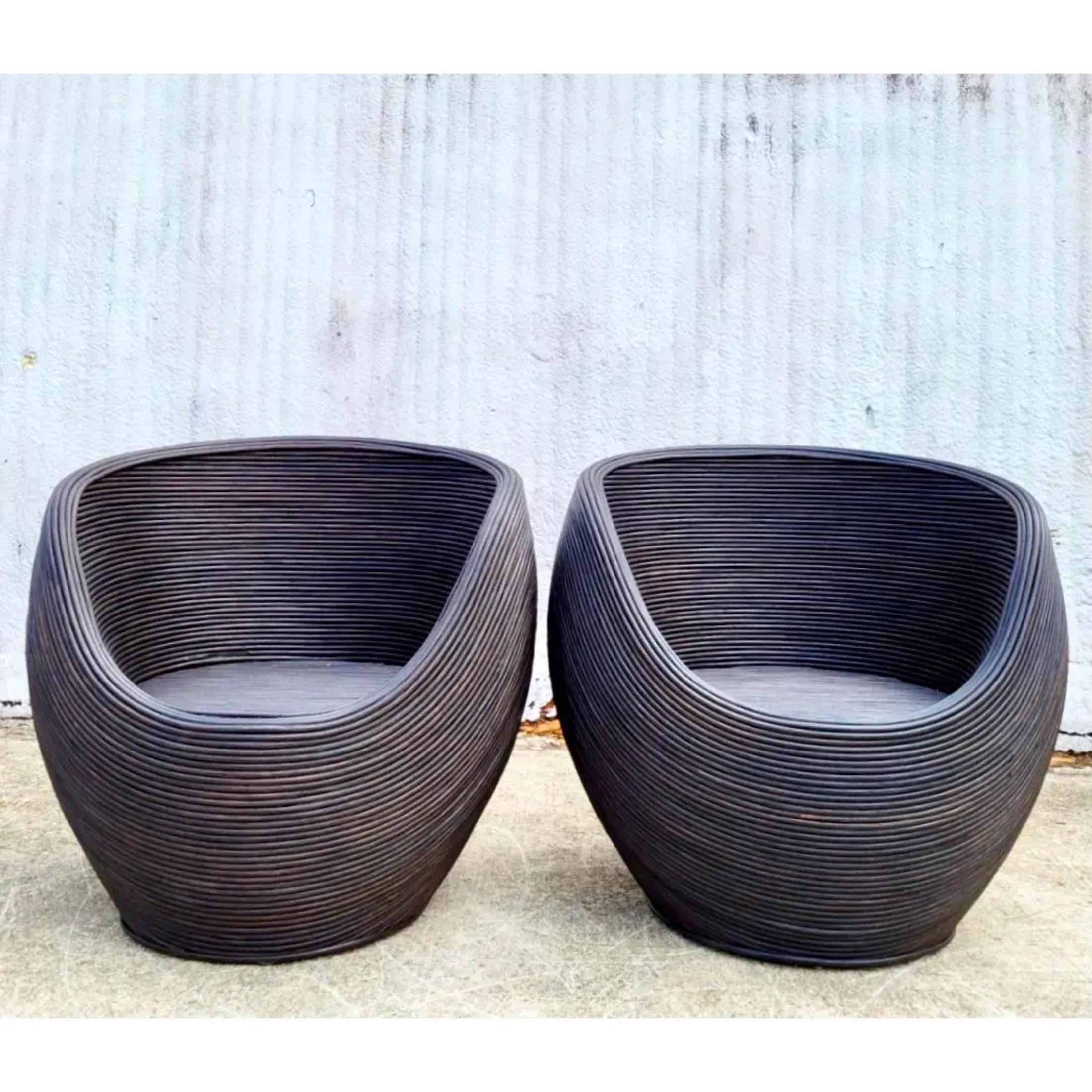 Fantastic pair of Coastal ebony pencil reed pod chairs. Beautiful organic shape in a deep rich brown- almost black. Flashes of the natural still peeking thru. Super chic addition to any decor. Acquired from a Palm Beach estate.