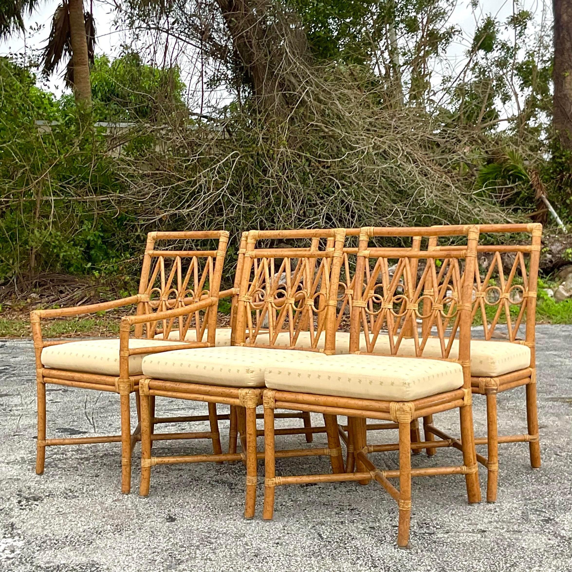 A stunning vintage Coastal dining set of 6. Made by the iconic Ficks Reed group and tagged below the chairs. Chic bent rattan in a ring motif. Acquired from a Palm Beach estate.

Side chairs 20.75x17.5x36.25
Table pedestal 32x28x29